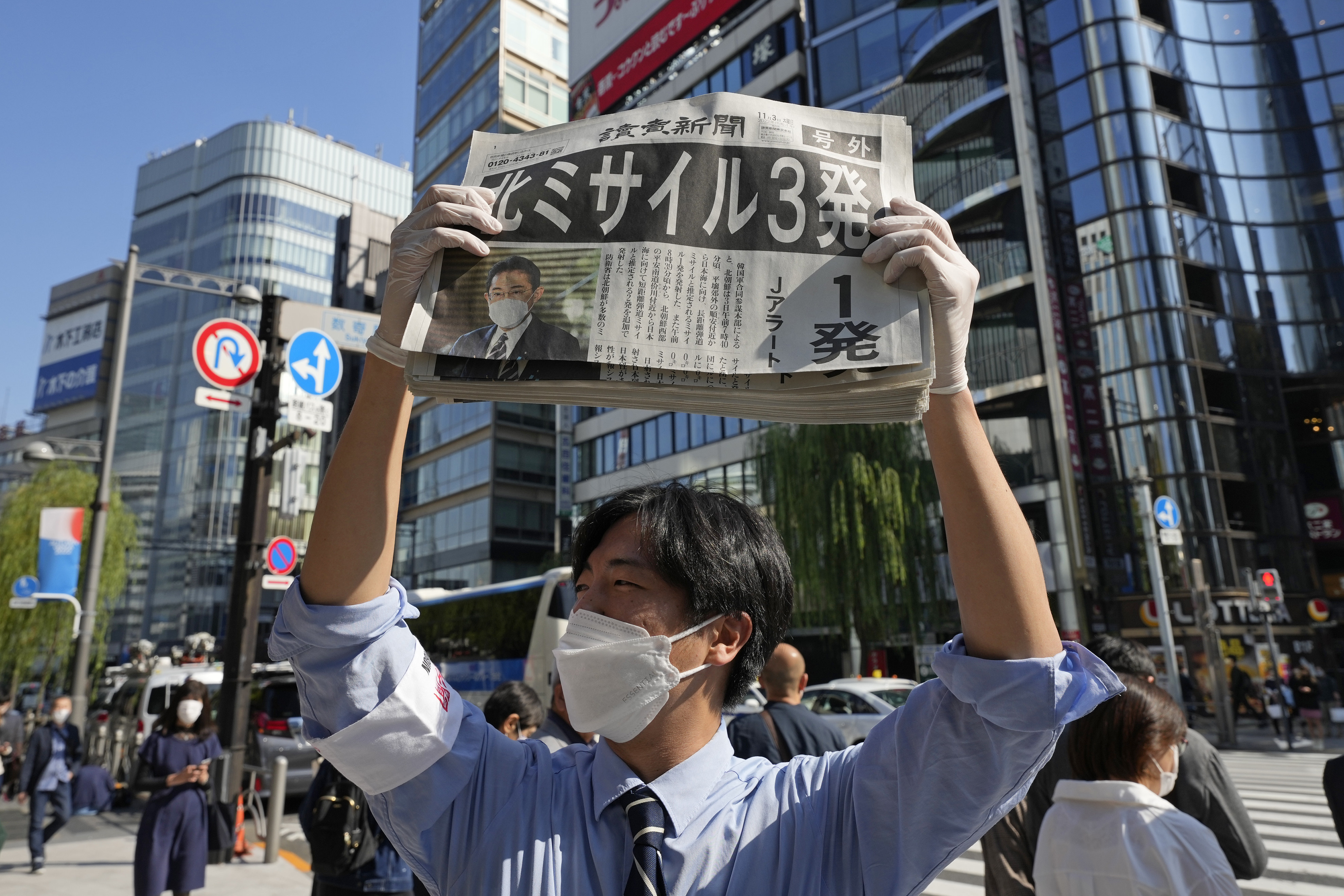 A newspaper seller distributes copies of the Yomiuri newspaper in Tokyo. Photo: AP