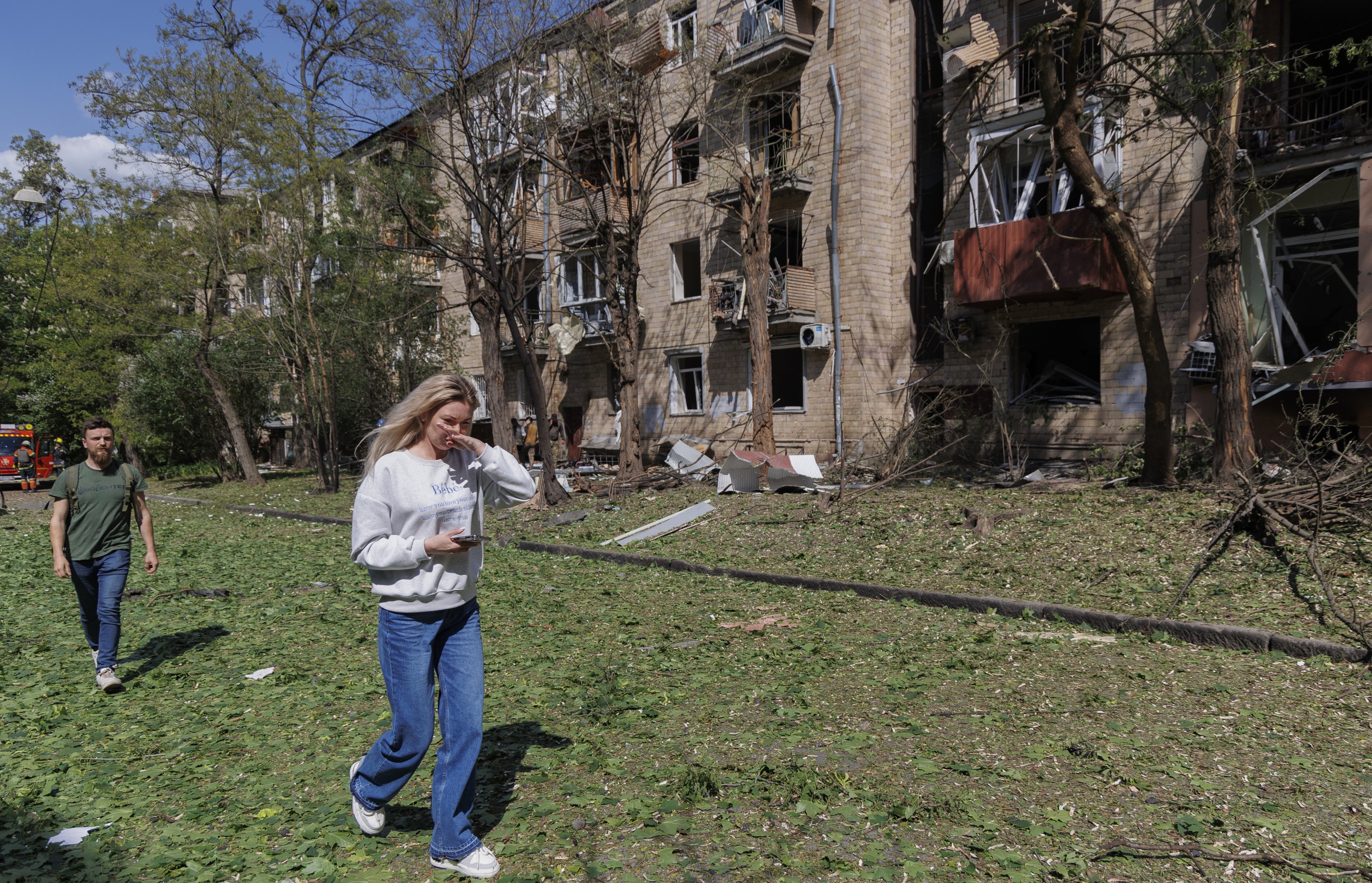 People walk past the scene of a Russian bomb attack on a residential building in Kharkiv, northeastern Ukraine on Sunday. Photo: EPA-EFE