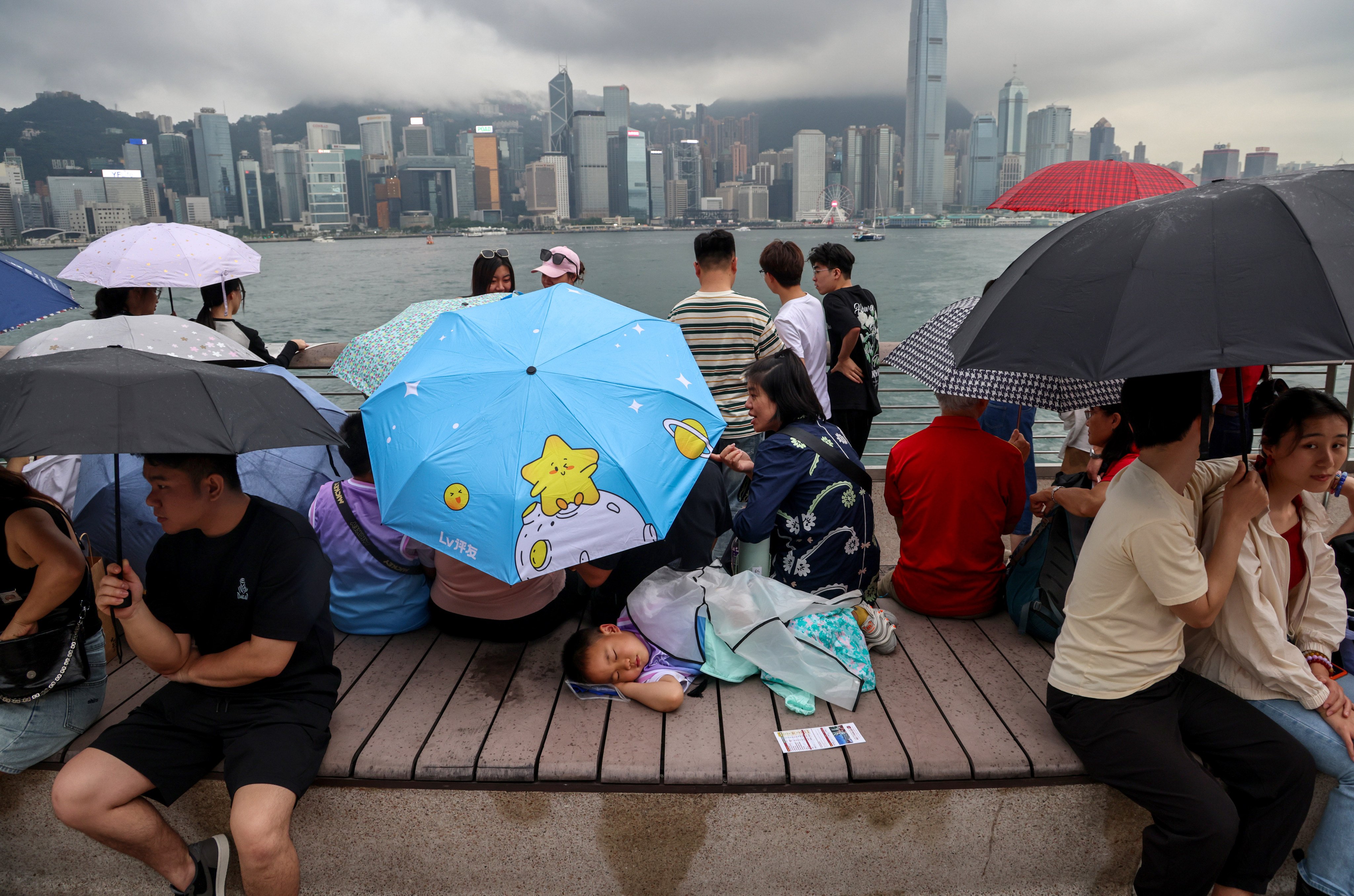 Tourists gather at Hong Kong’s Tsim Sha Tsui waterfront area on a rainy day on May 2. With the Hong Kong economy facing headwinds, much of which are outside its control, Hongkongers need to brace themselves for a few years of hardship. Photo: Jelly Tse