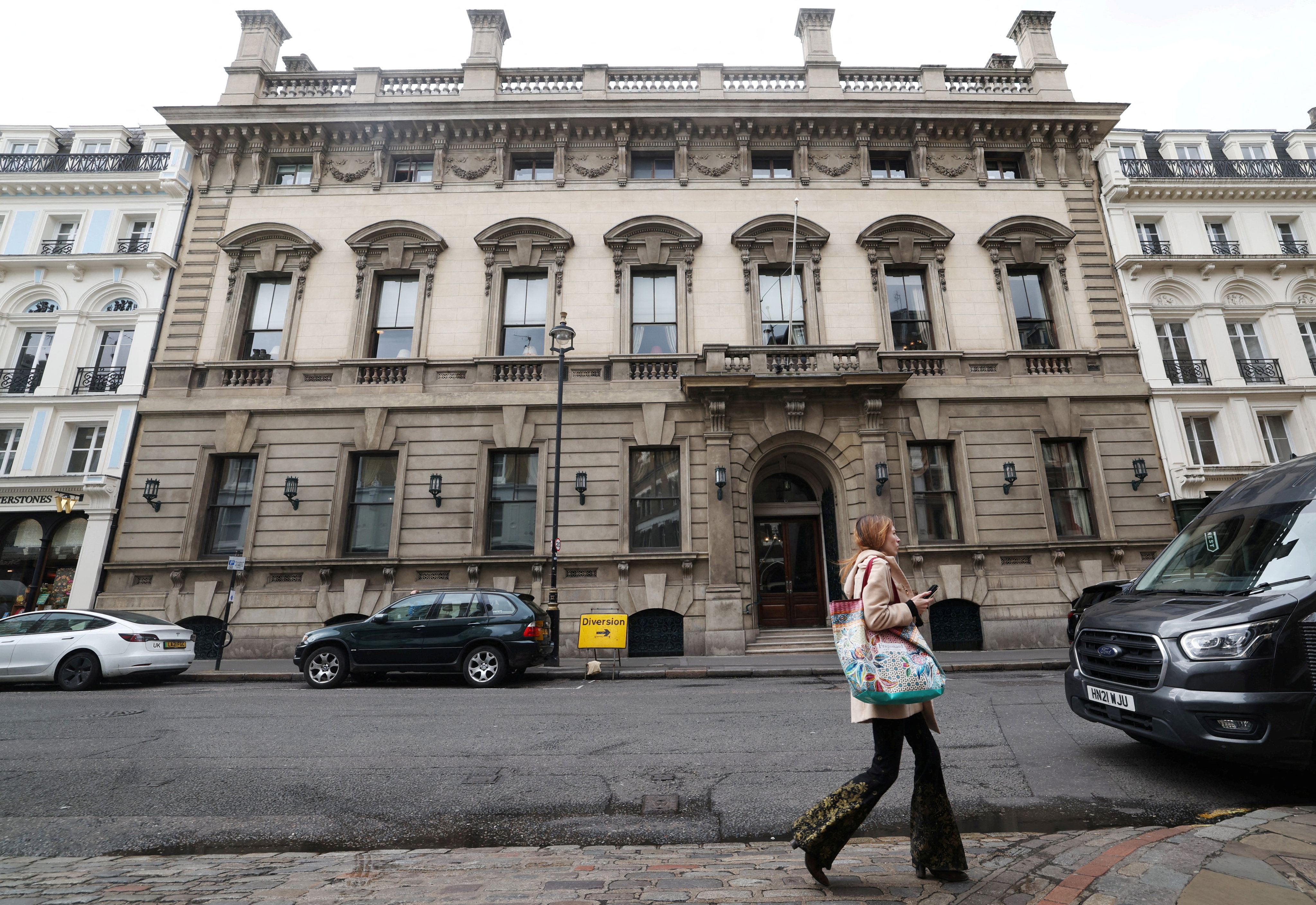 A person walks past the entrance to the Garrick Club, a private member’s club in London, which has voted to finally allow female members. Photo: Reuters