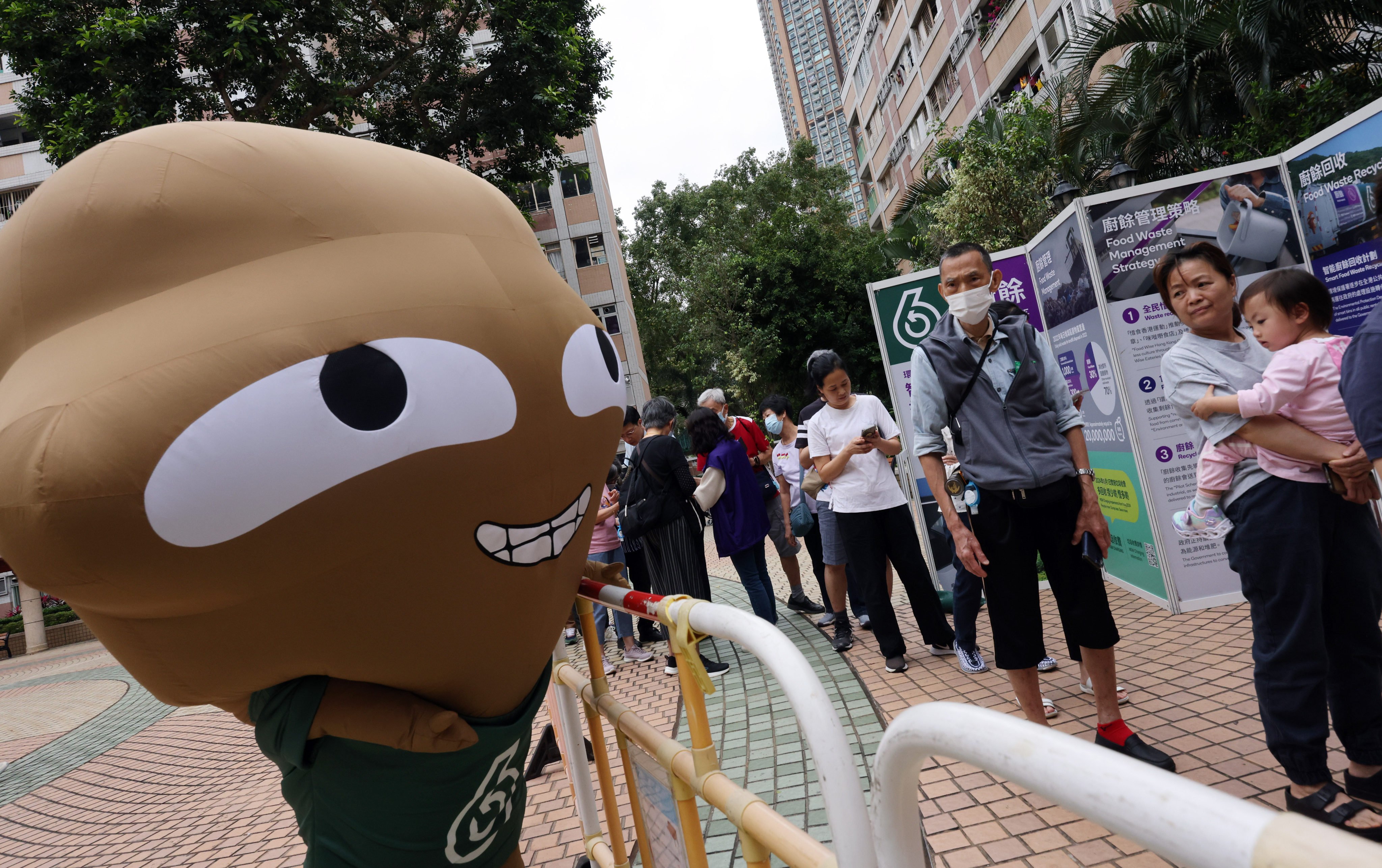 A “Big Waster” mascot interacts with residents of the Moon Lok Dai Ha estate in Tsuen Wan on April 9. Photo: Jelly Tse