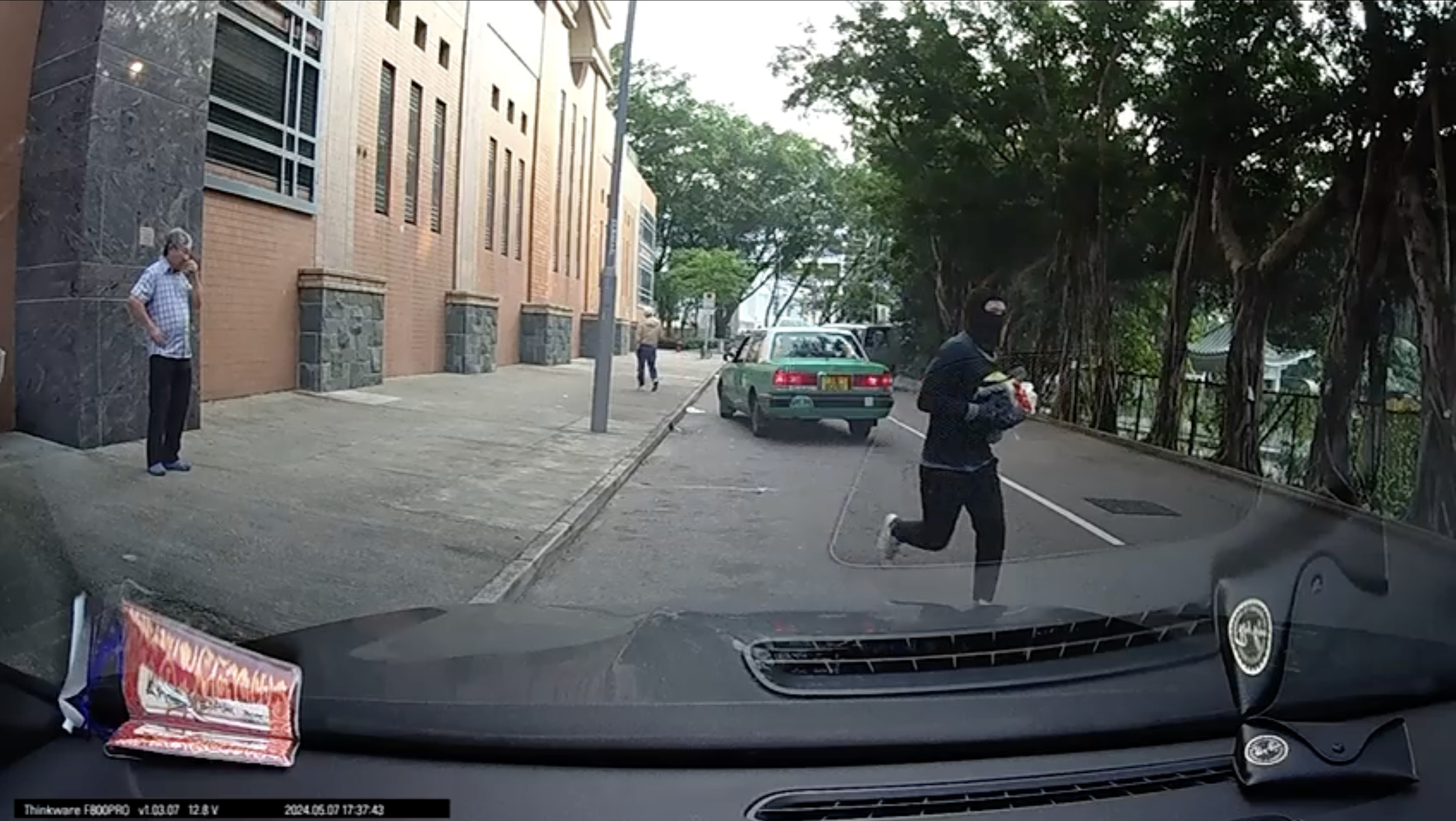Dashcam footage shows one of the robbers making off with the stolen goods. Photo: Handout
