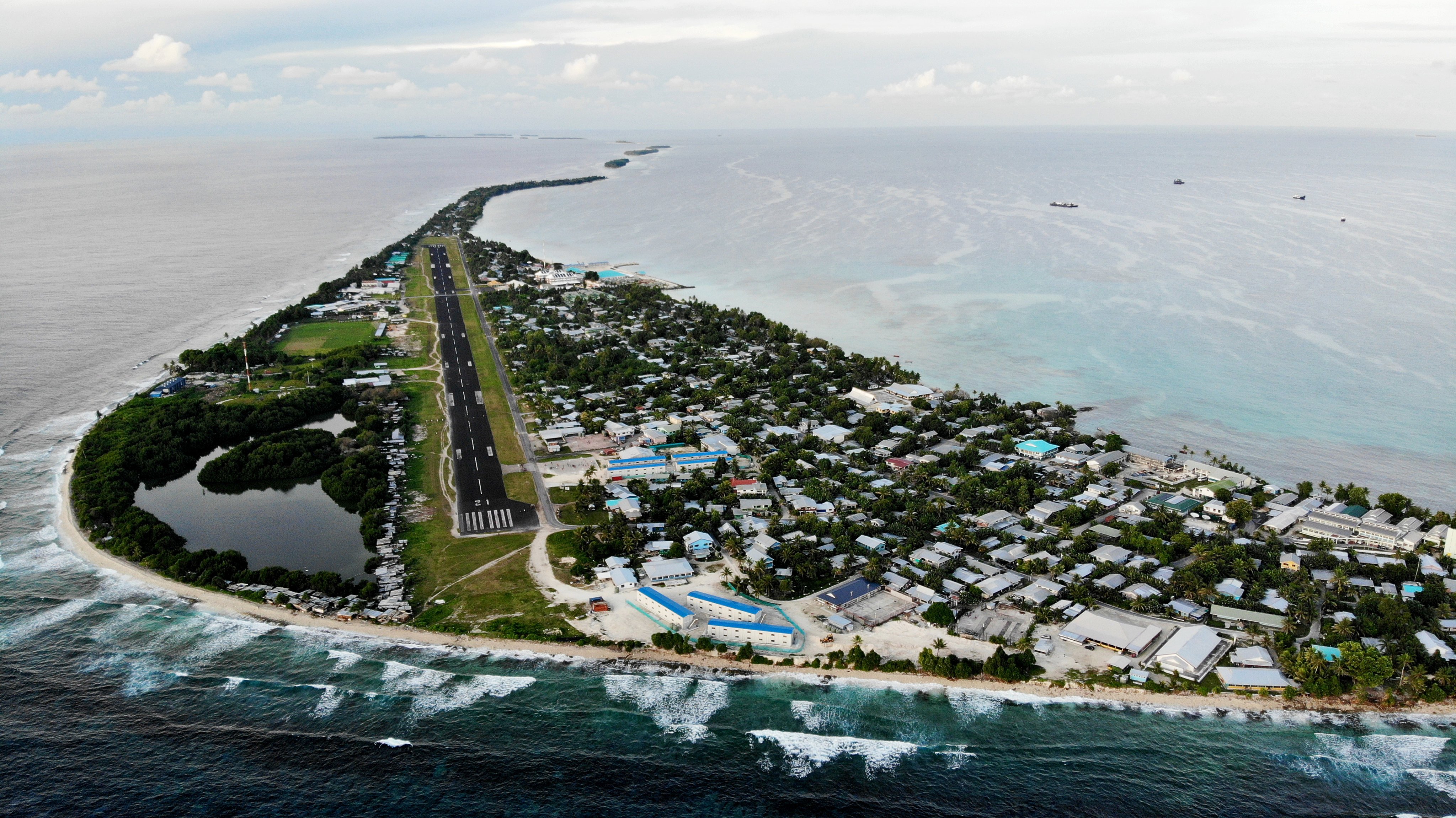 An aerial view of downtown and the airport runway in Funafuti, Tuvalu. Australia  said it will quadruple its financial help to Tuvalu, as China also courts small island states. Photo: Getty Images