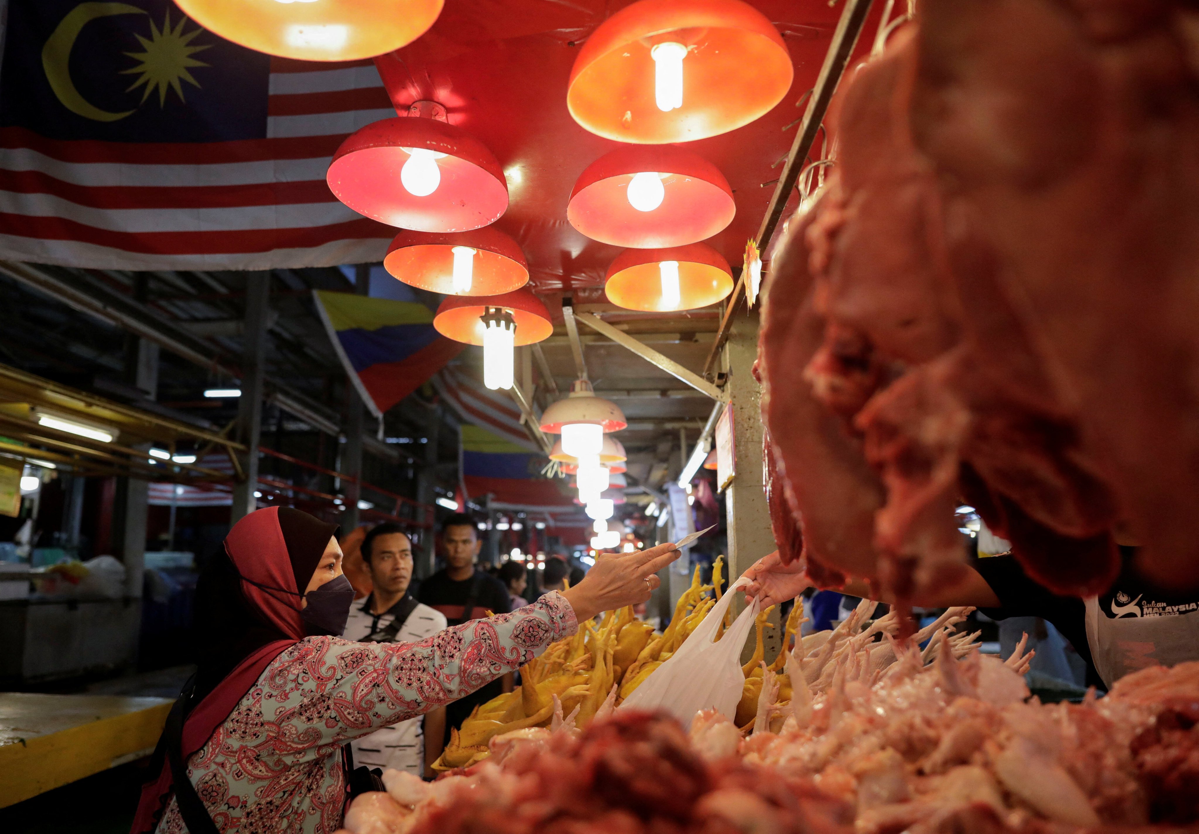 Many low-income families in Kuala Lumpur are struggling to afford basic foods like rice and chicken amid soaring living costs. Photo: Reuters