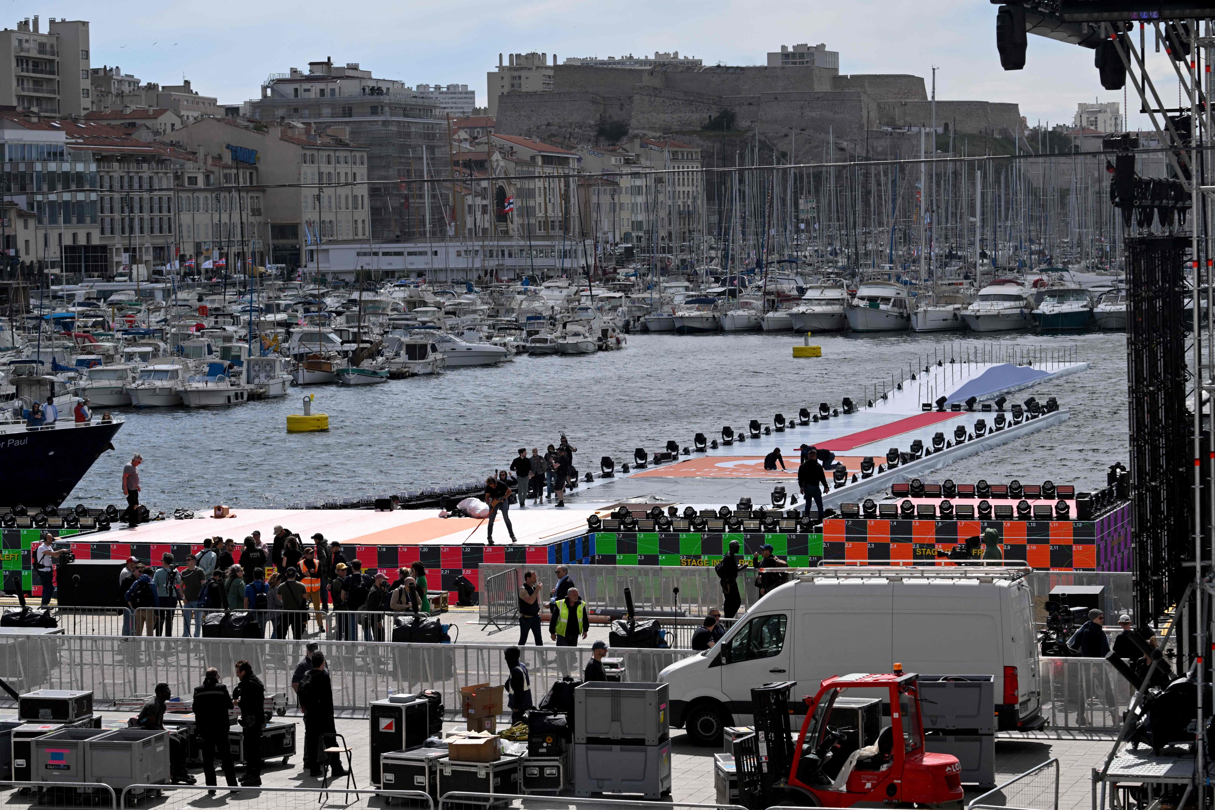 The temporary infrastructure under construction at the Vieux-Port (Old Port), set to welcome the three-masted ship Belem bearing the Olympic torch, on the eve of its arrival in Marseilles. Photo: AFP