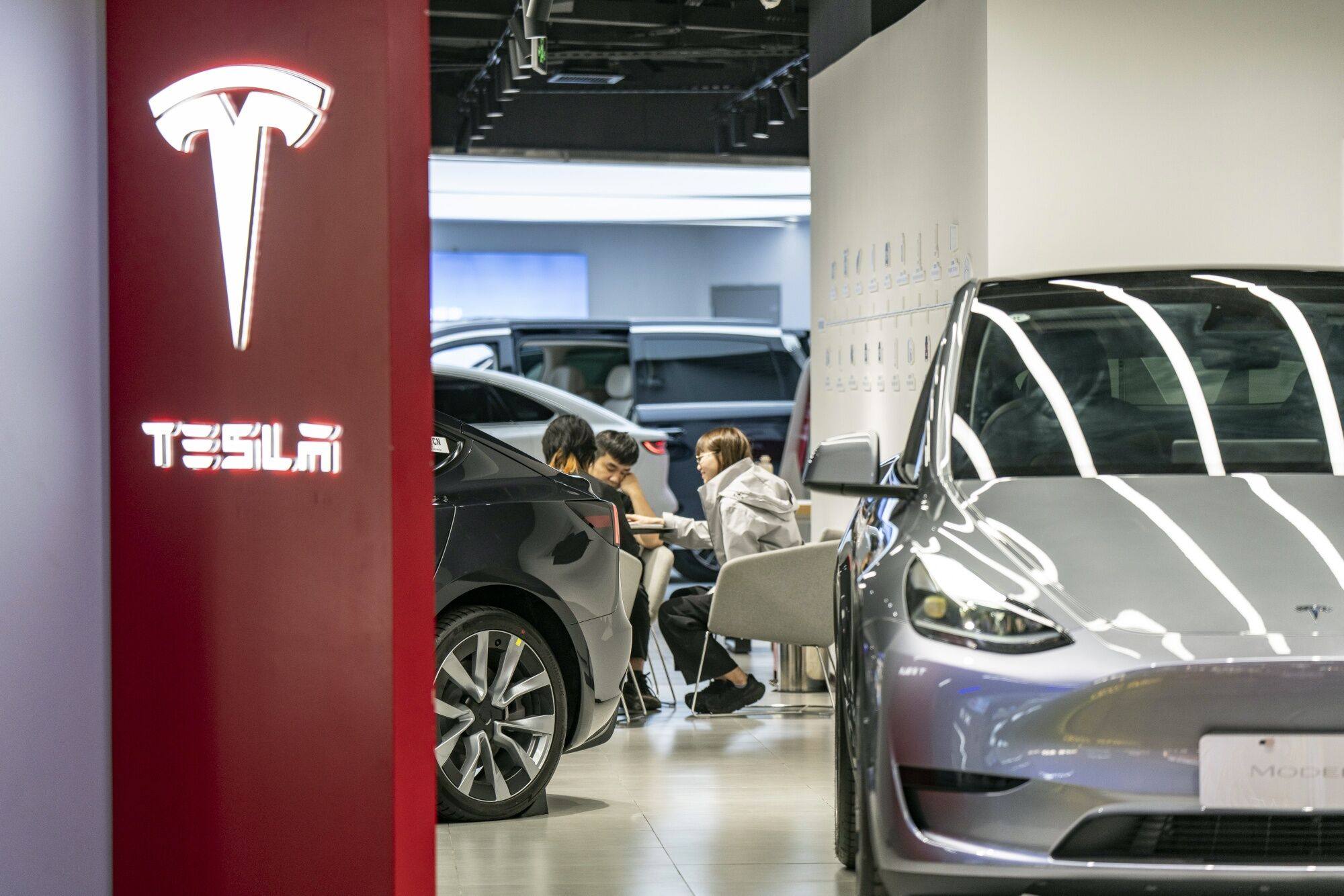 Customers seen inside a Tesla showroom in Shanghai on April 29, 2024. Photo: Bloomberg