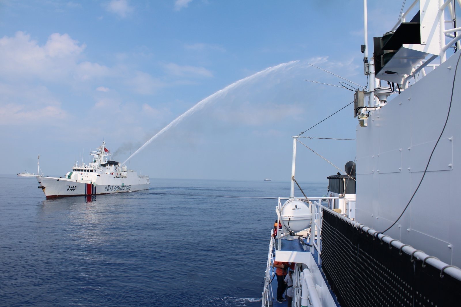 A Chinese Coast Guard ship fires a water cannon on a Philippine Coast Guard vessel near Scarborough Shoal in the South China Sea on April 30. Photo: EPA-EFE/Philippine Coast Guard