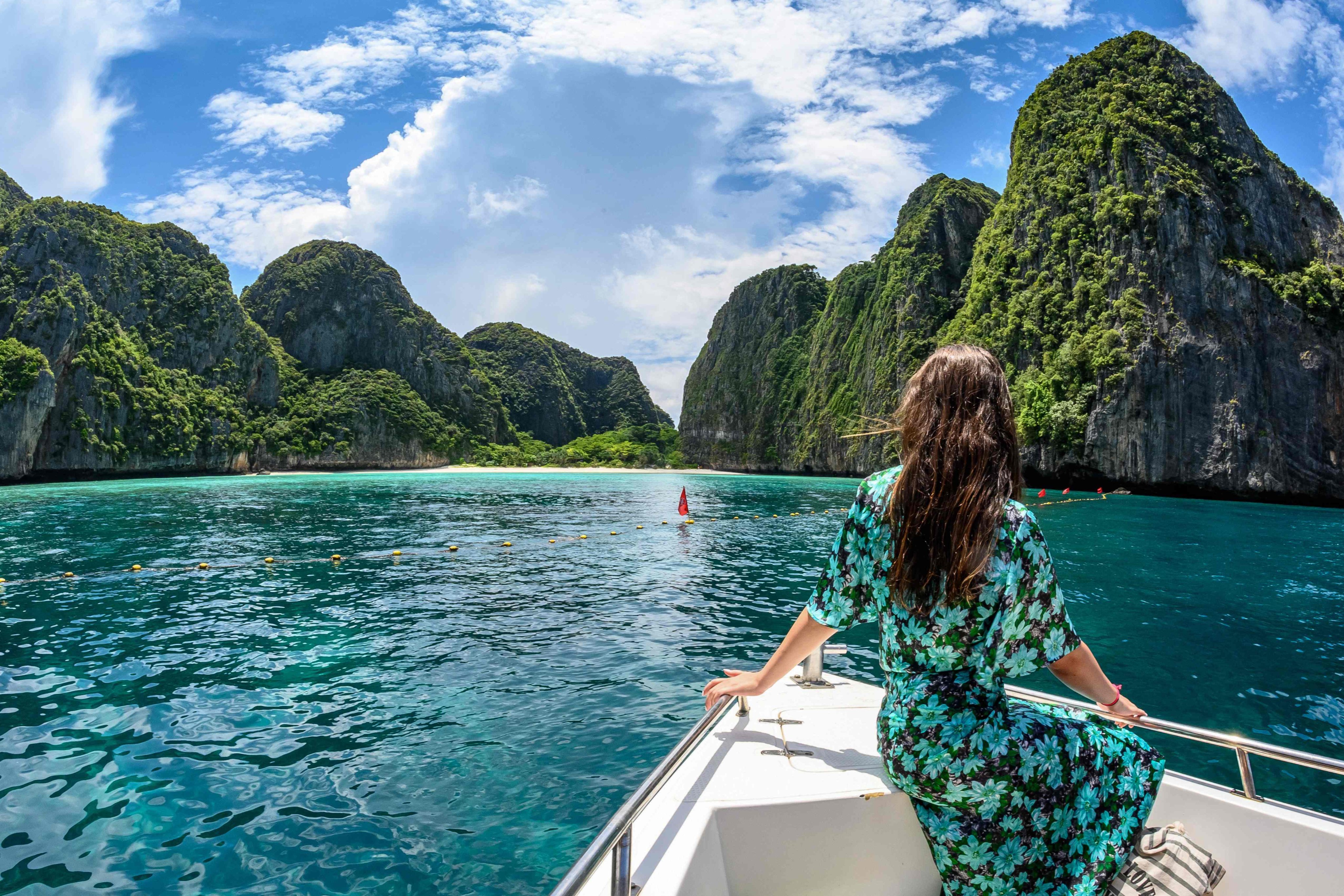 A tourist poses for a photo on a boat near the southern Thai island of Koh Phi Phi. Photo: AFP