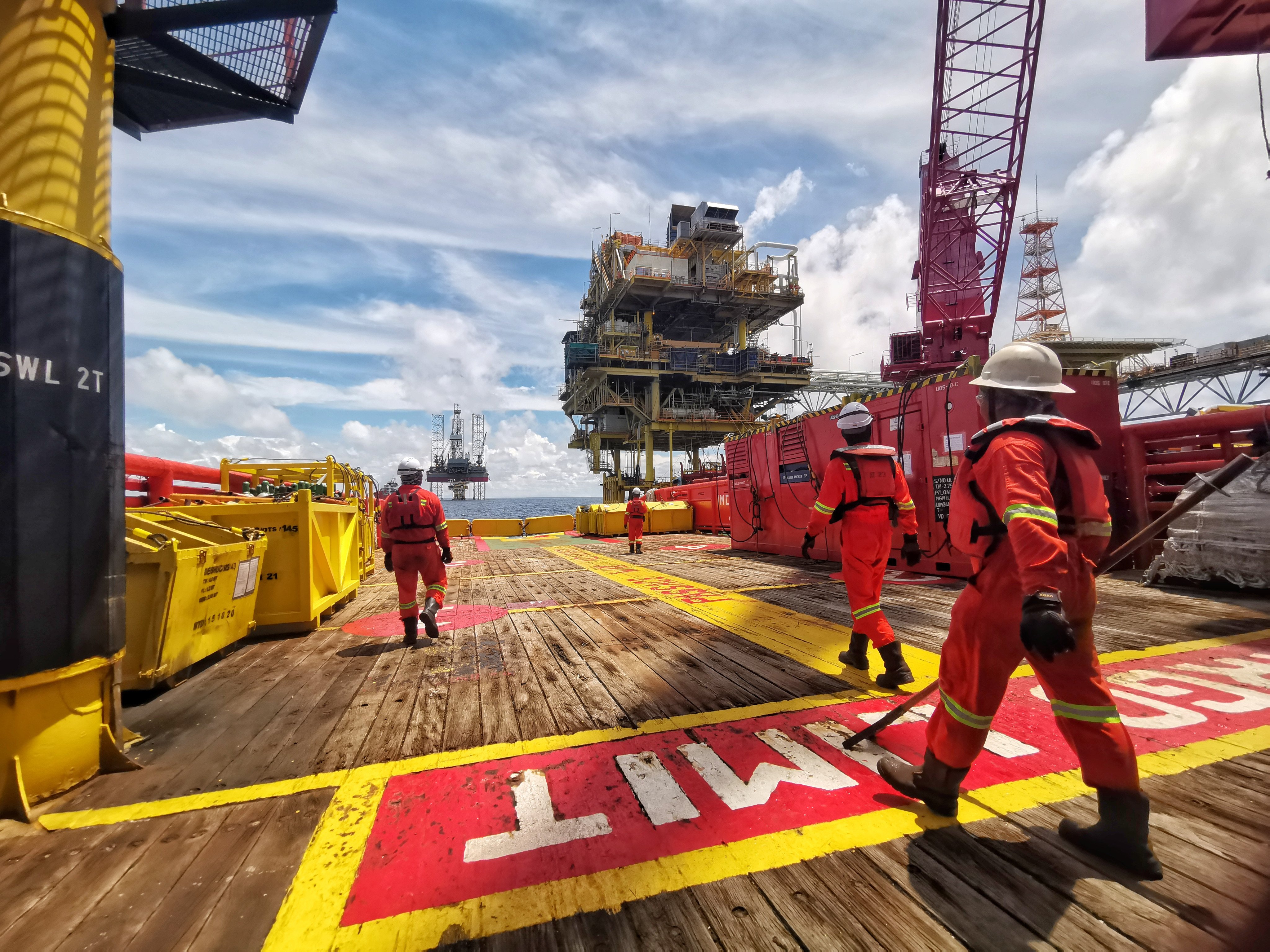Offshore marine crew stand by on deck during cargo transfer from vessel to oil platform at sea, off Sabah. Malaysia’s maritime assets are notoriously poorly funded and unable to fully patrol waters, analysts say. Photo: Shutterstock
