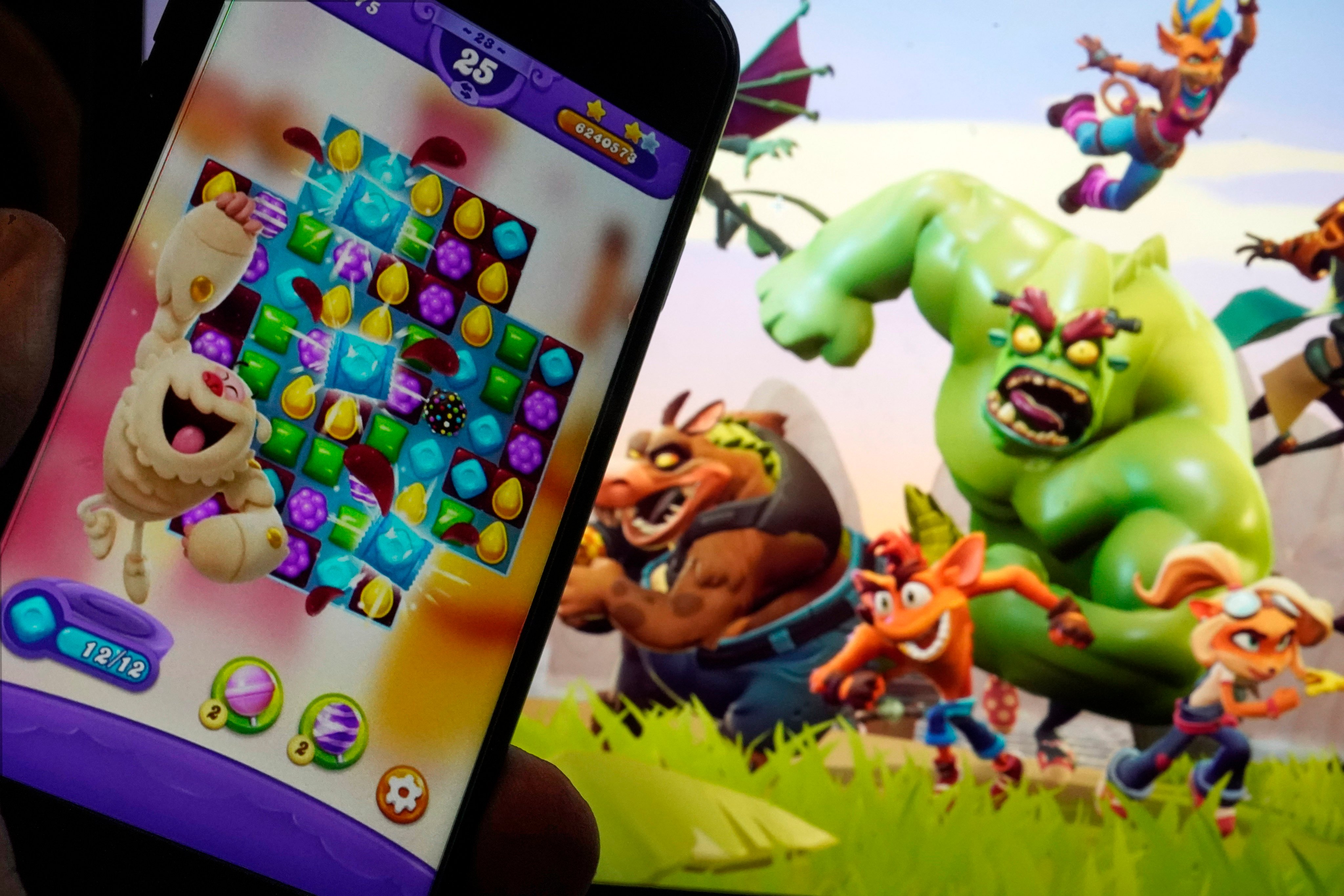 Scenes from Candy Crush Saga, left, and Crash Team Rumble, are shown in this photo, in New York, June 21, 2023. Photo: AP