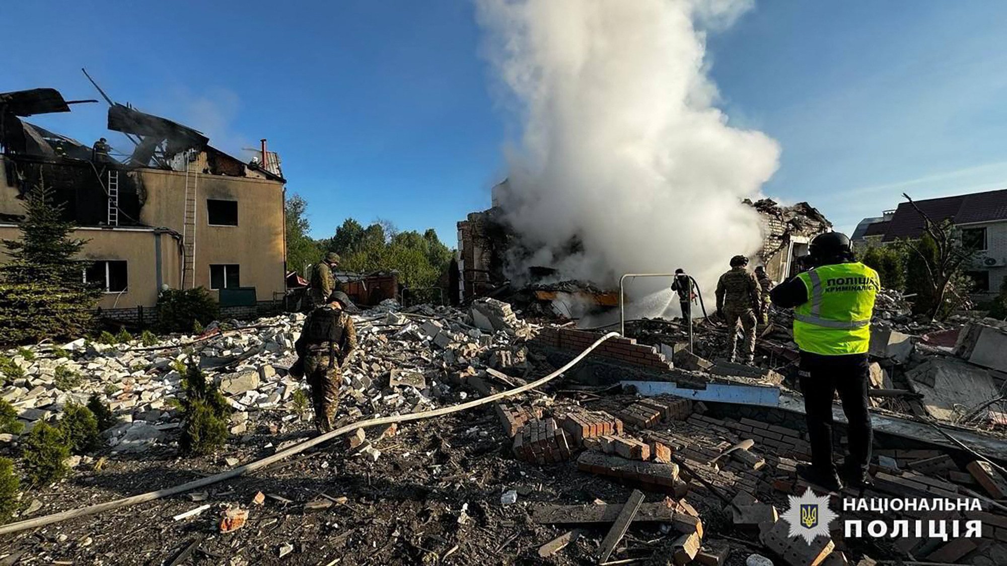 Crews extinguish fires of private houses destroyed by a shelling in Kharkiv, eastern Ukraine. Photo: National Police of Ukraine/AFP