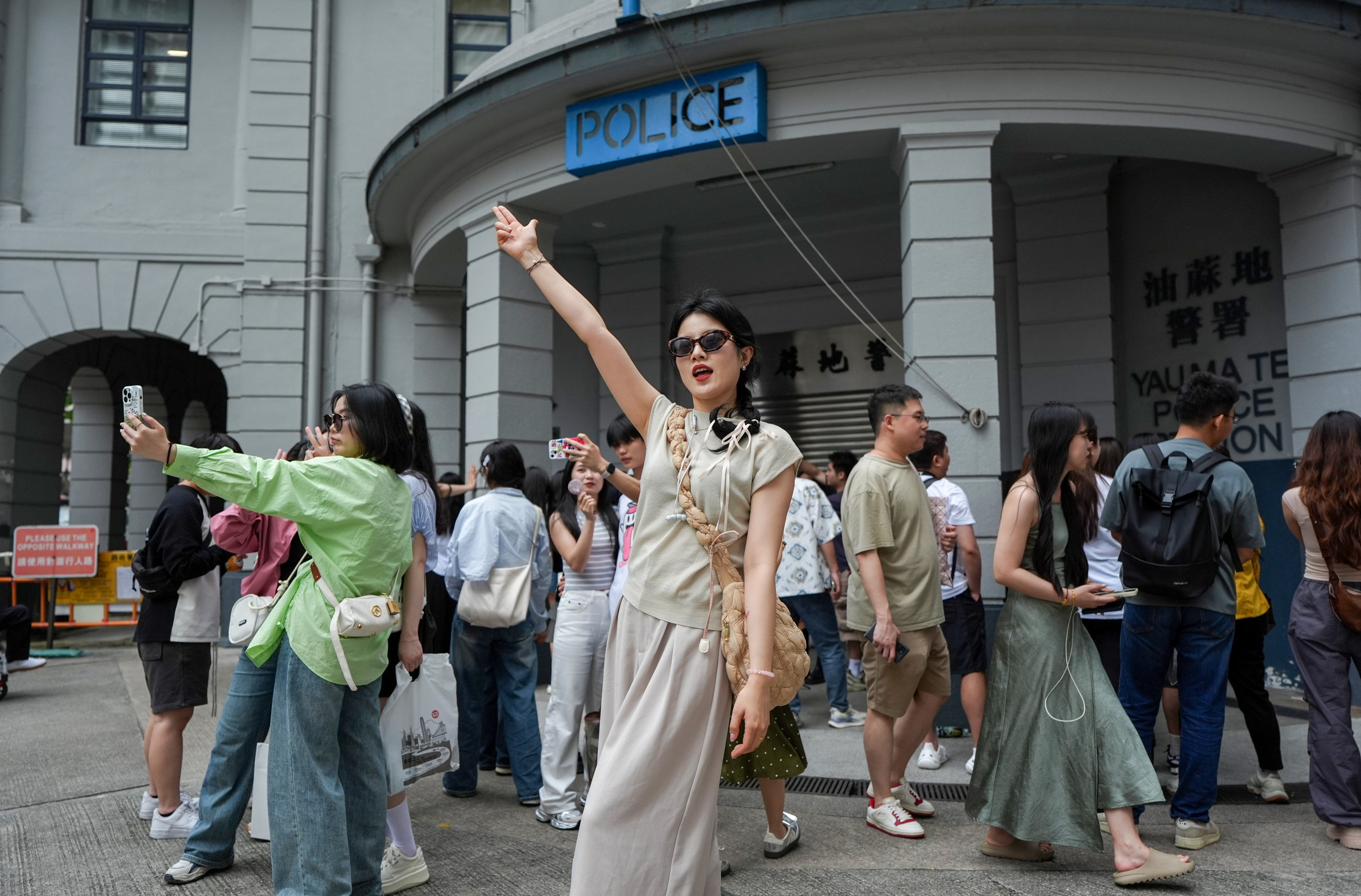 Tourists pose for photos outside Yau Ma Tei Police Station during the recent “golden week” break. Photo: Eugene Lee