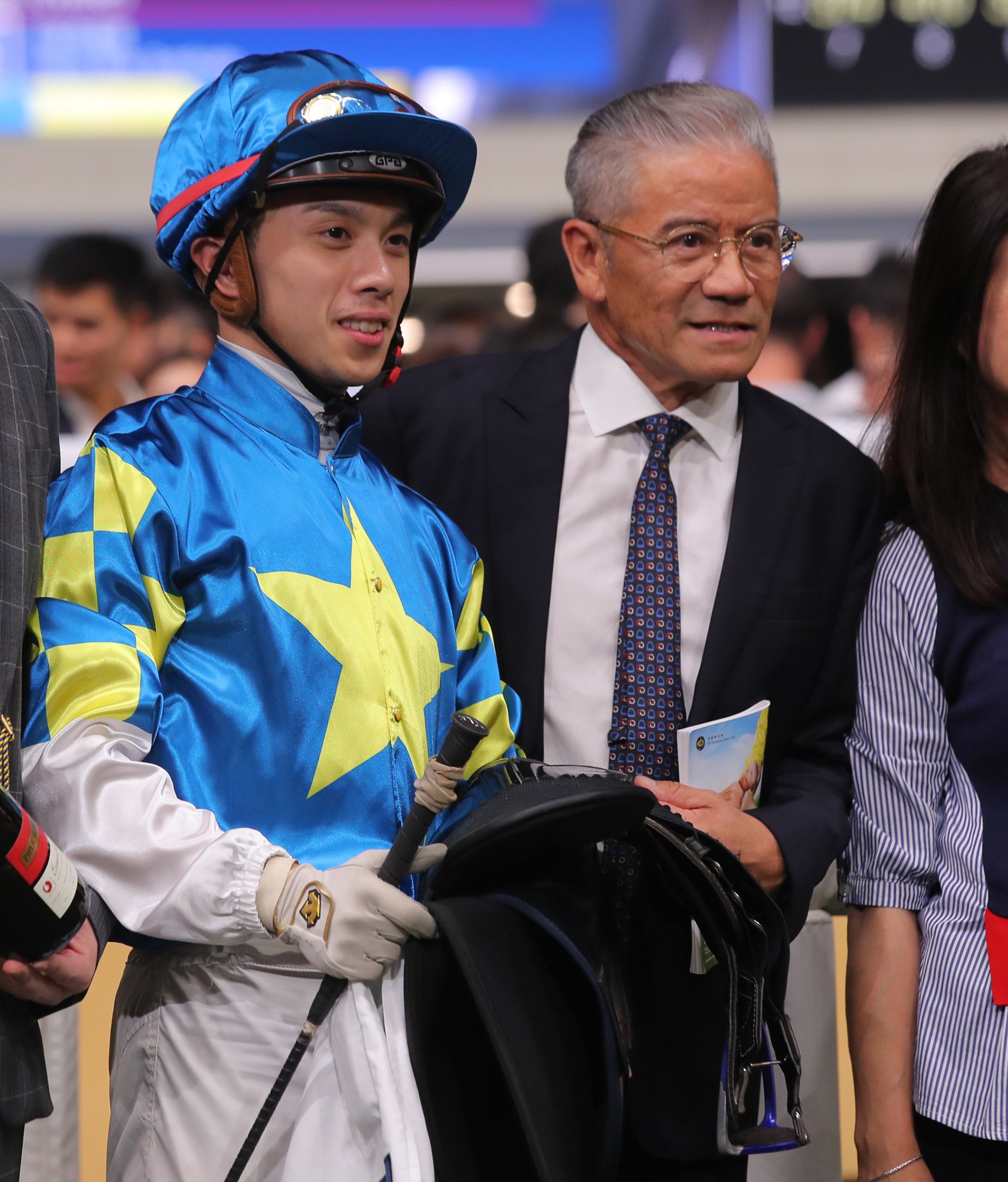 Jockey Angus Chung celebrates Lovero’s victory with old boss Tony Cruz on Wednesday night.