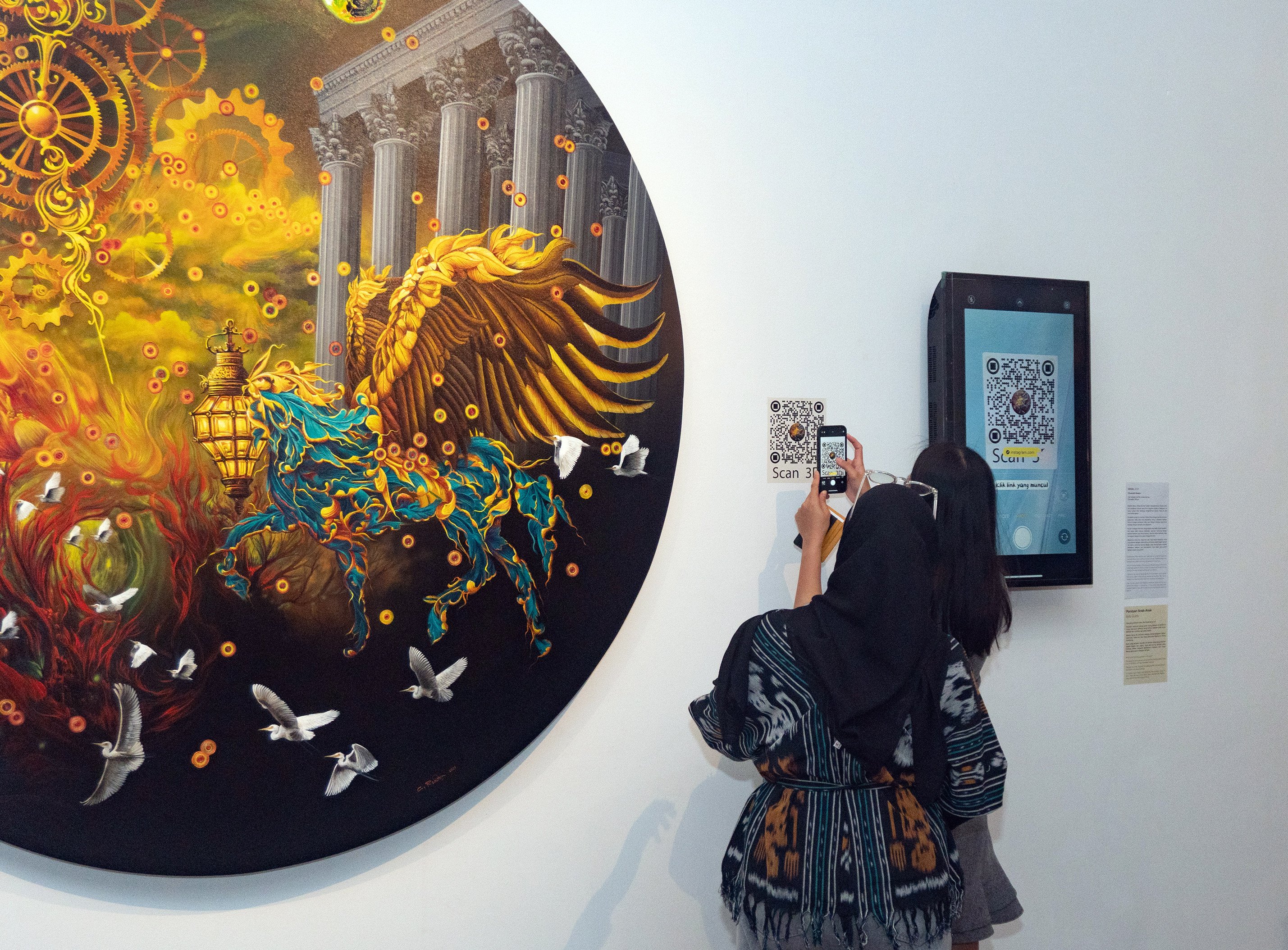 Visitors admiring artworks at the 2023 Biennale Jatim in Indonesia. Photo: Orasis Art Space 