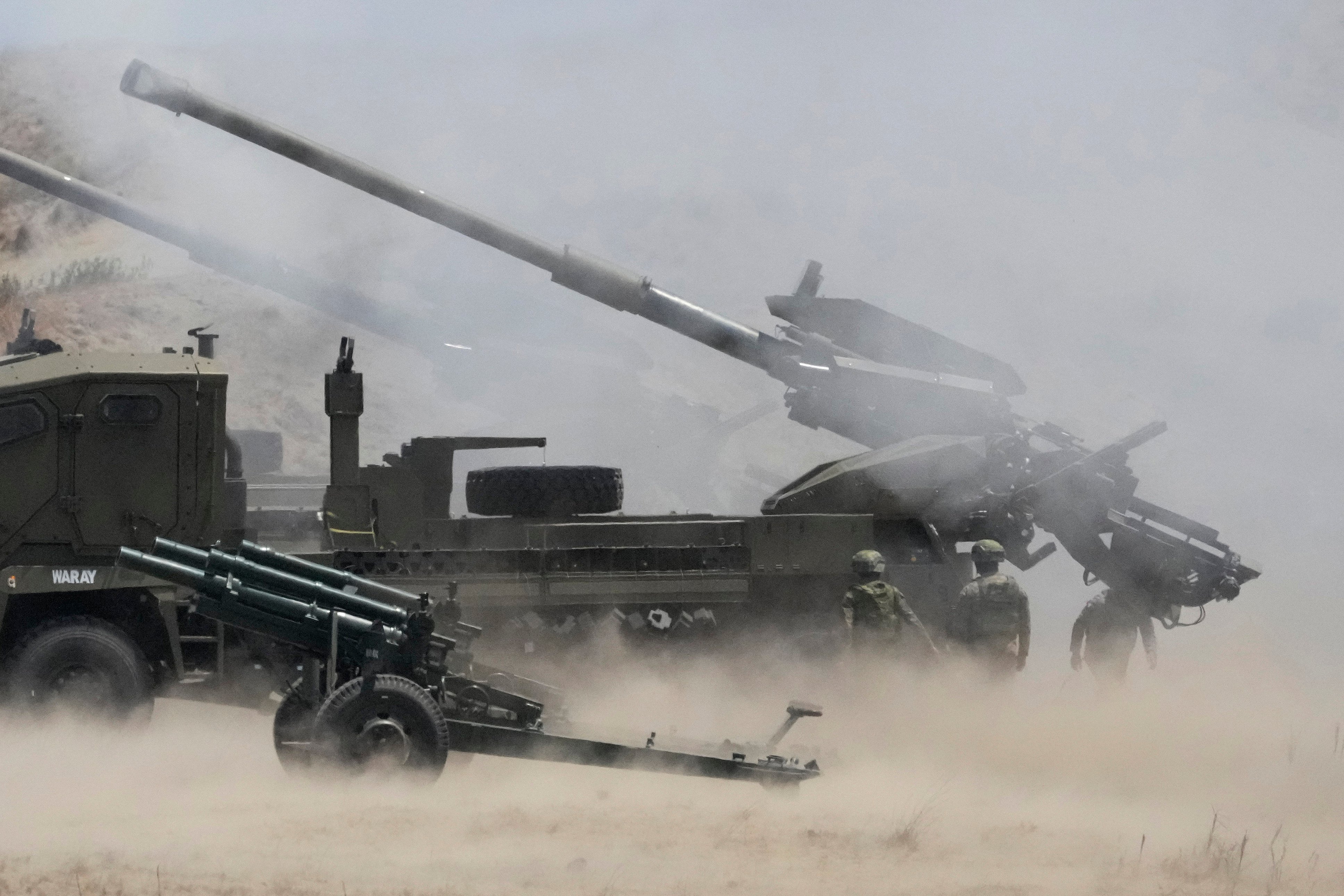 Dust billows as Philippine soldiers fire ATMOS 155mm howitzers during a joint military exercise on Wednesday in Laoag, Ilocos Norte, northern Philippines. Photo: AP