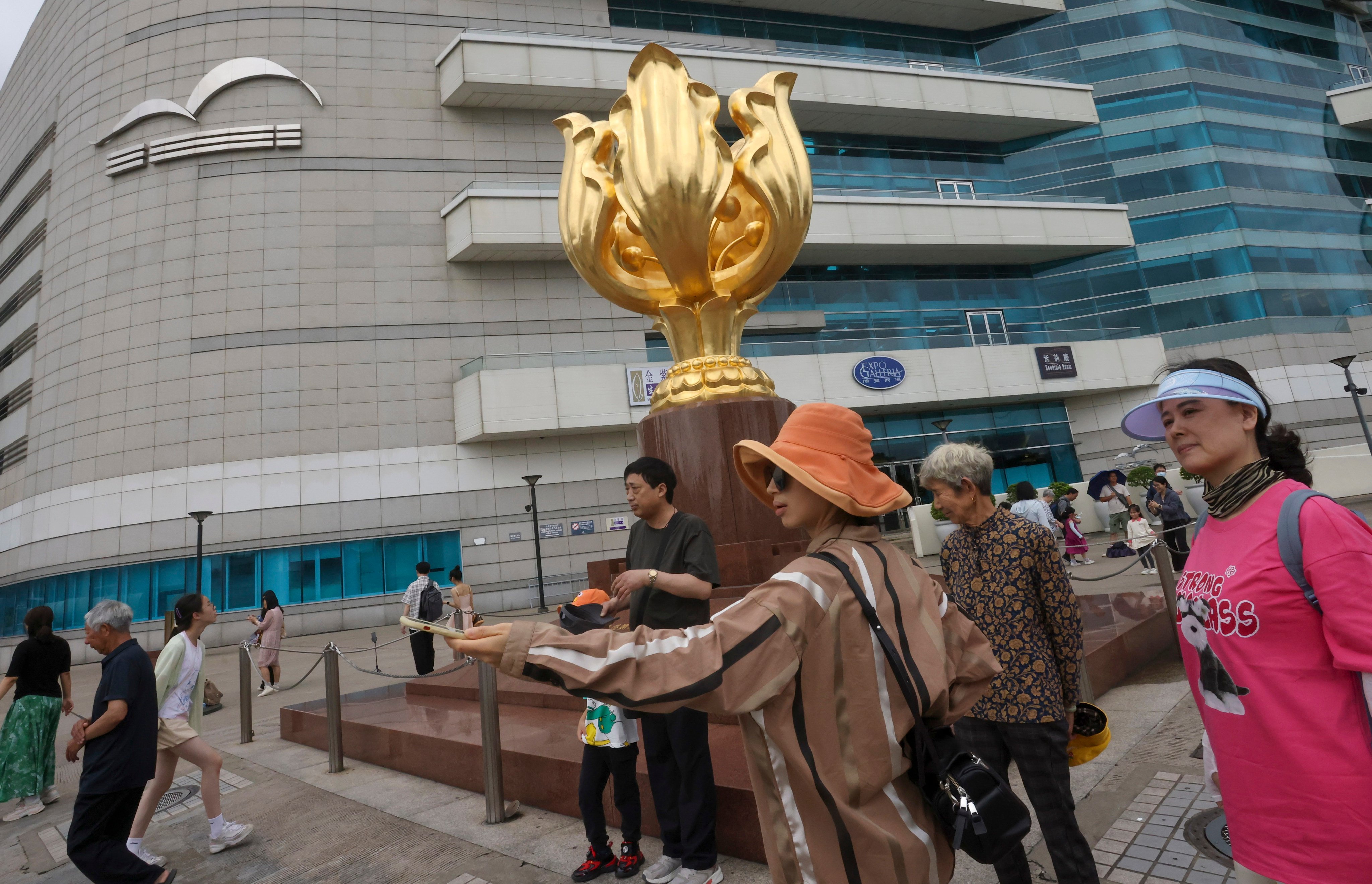 Tourists at Golden Bauhinia Square. An industry head says the latest update is a “strategic move” as it will enhance Hong Kong’s role as an aviation hub. Photo: Jonathan Wong