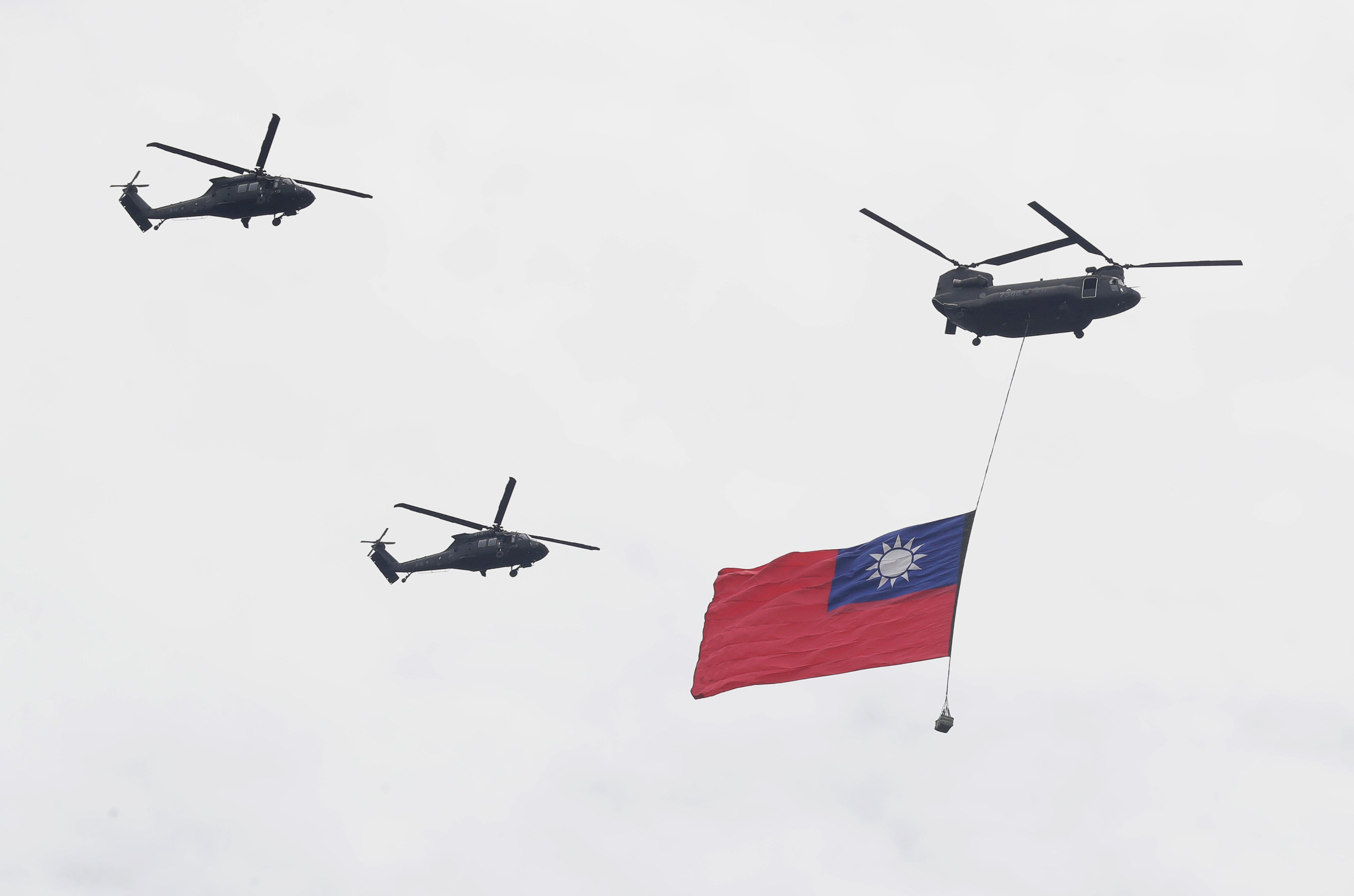 Helicopters fly with Taiwan’s flag on Tuesday, practicing for the presidential inauguration scheduled for May 20. Photo: AP 