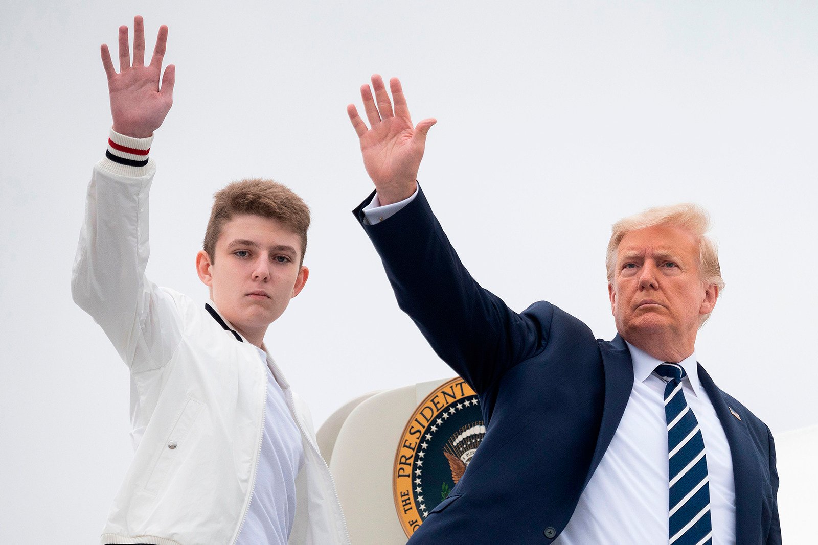 US President Donald Trump and his son Barron wave as they board Air Force One in Morristown, New Jersey, in August 2020. Photo: TNS