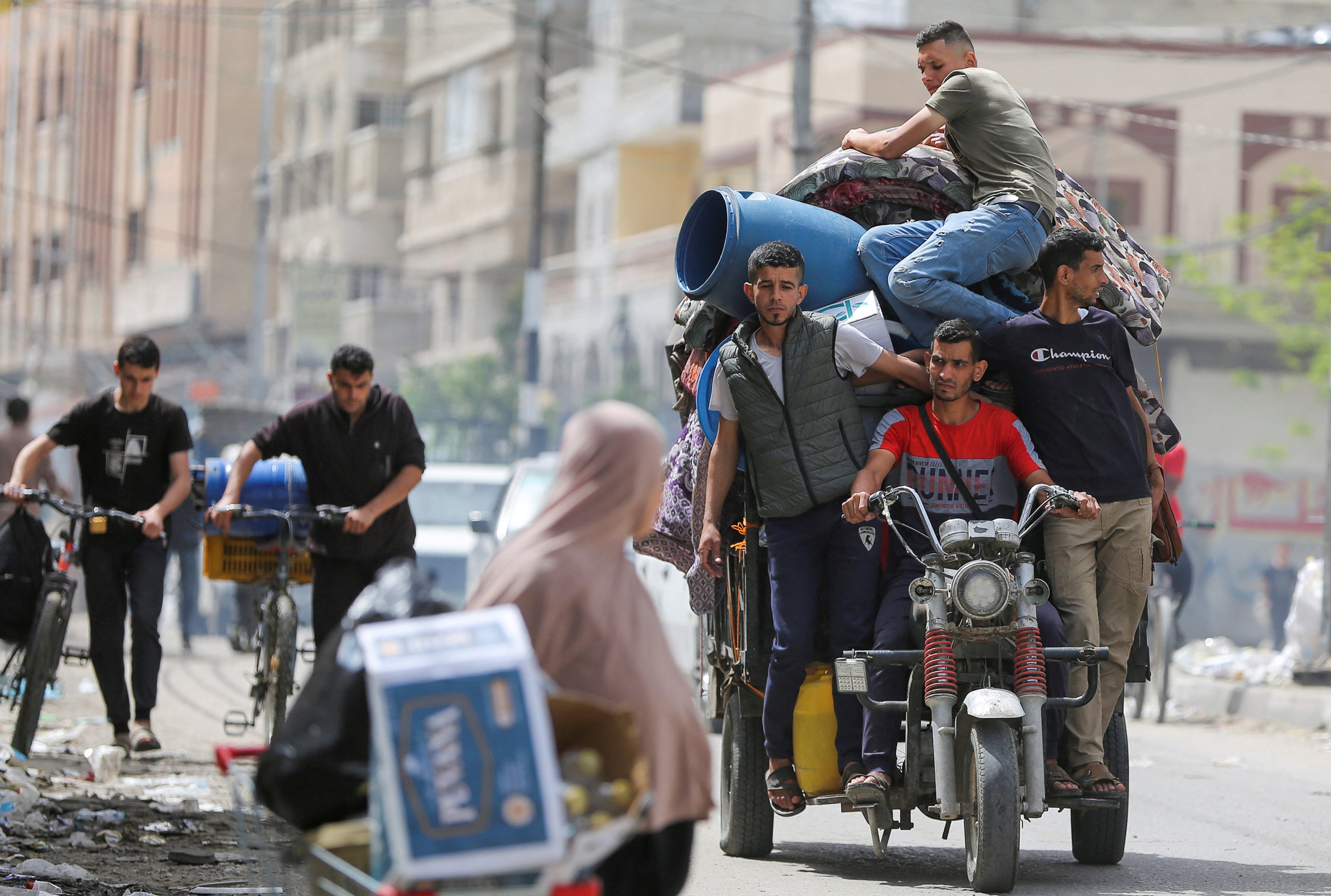 People ride on a vehicle loaded with belongings on Saturday, as Palestinians prepare to evacuate, after Israeli forces launched a ground and air operation in the eastern part of Rafah. Photo: Reuters
