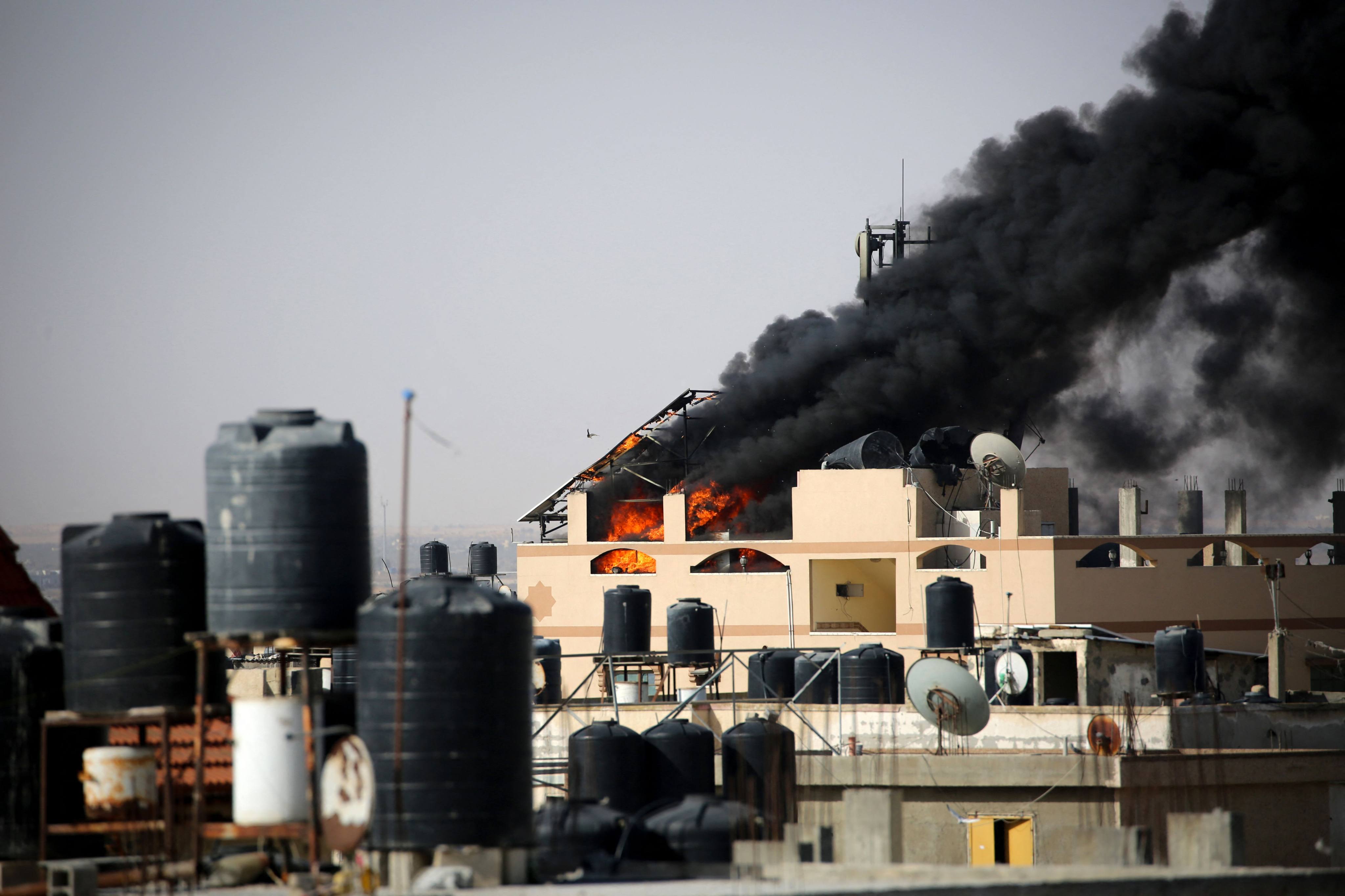 Black smoke rises from a building after Israeli bombardment in Rafah on Friday. Photo: AFP