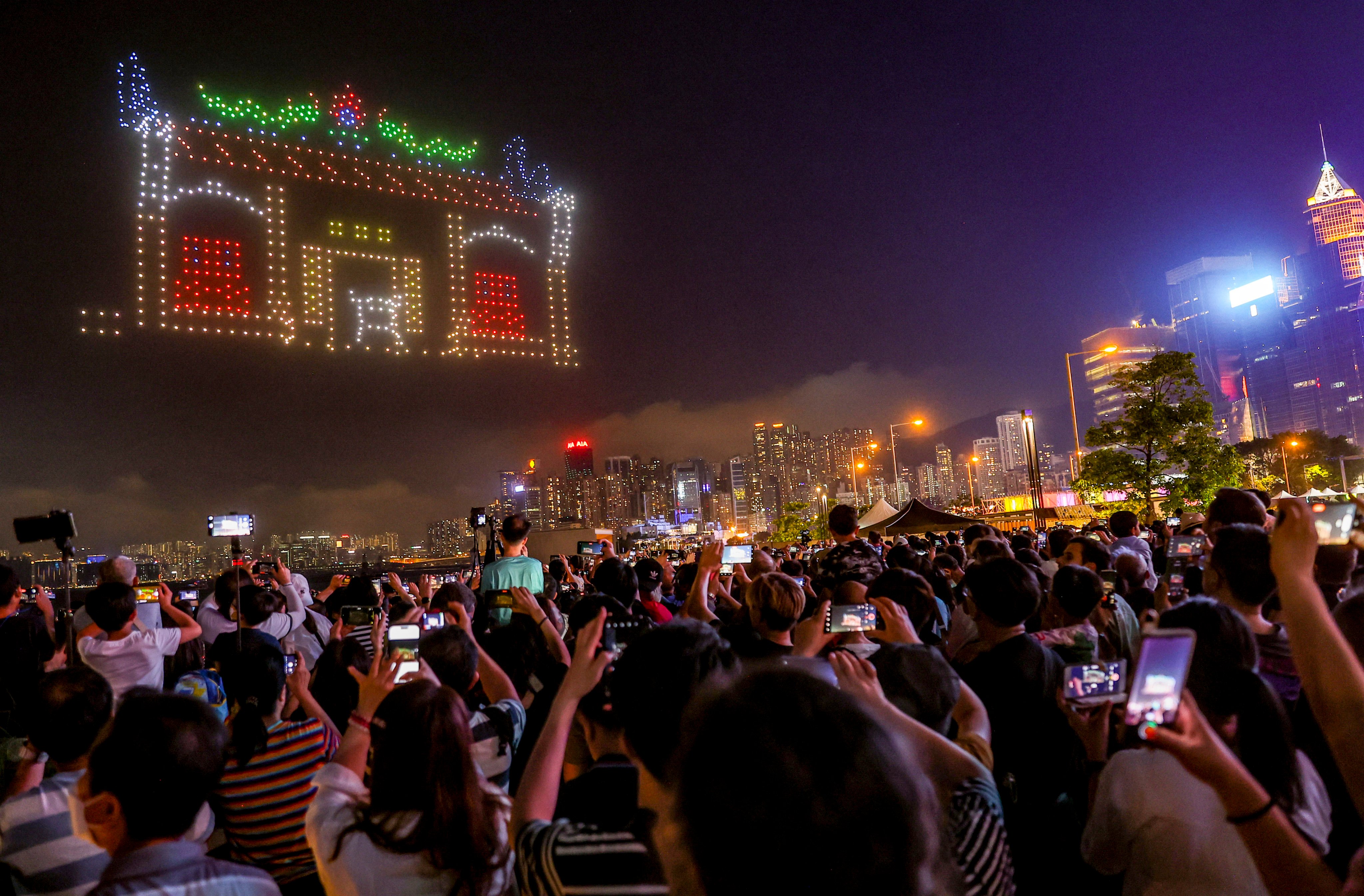 Residents and tourists watch Saturday night’s drone show. Photo: Edmond So