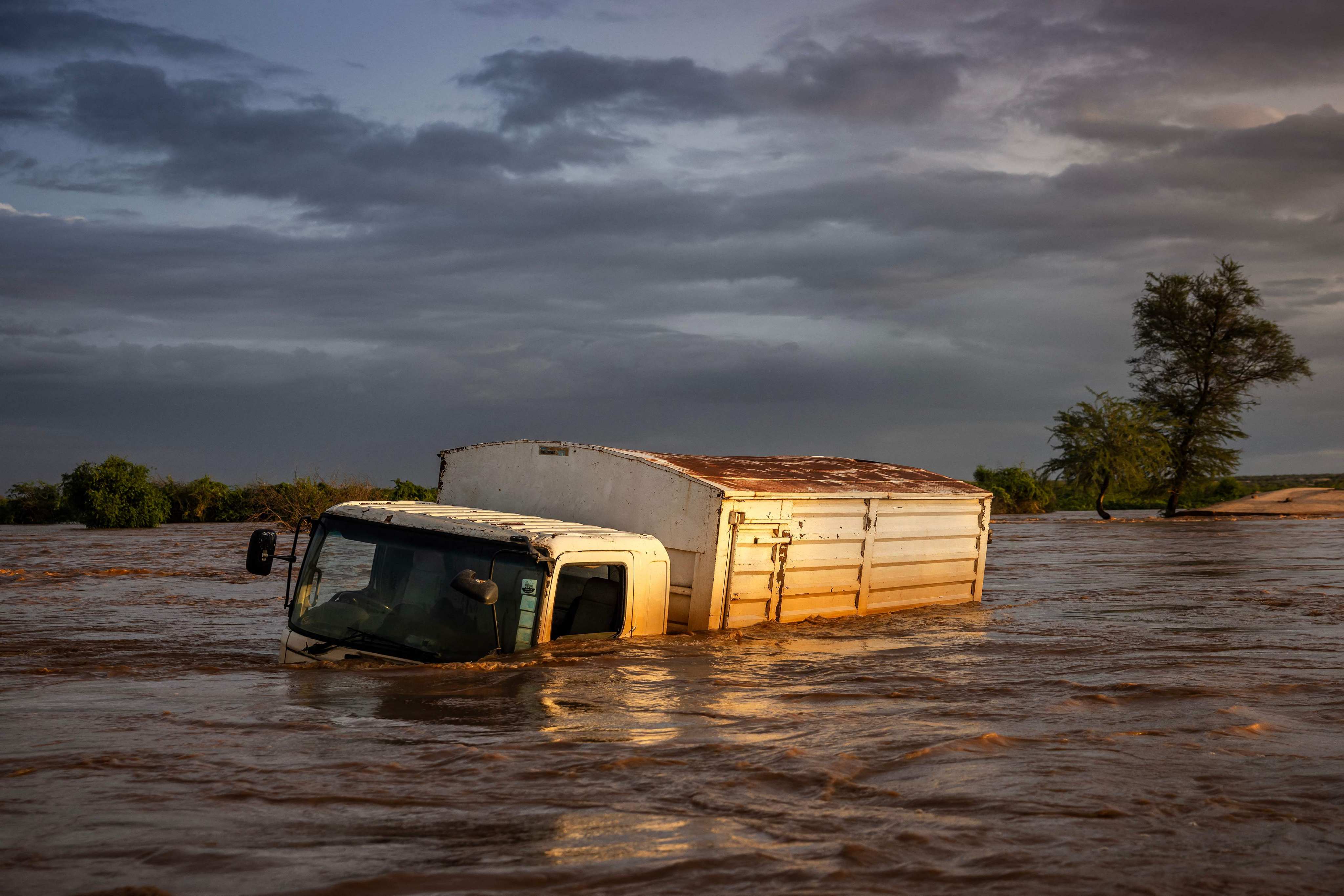 A truck sits submerged in flood waters following the destruction of a main road amid flash floods in Garissa, Kenya, on May 8. Kenya is grappling with one of its worst floods in recent history, the latest in a string of weather catastrophes, following weeks of extreme rainfall scientists have linked to a changing climate. Photo: AFP