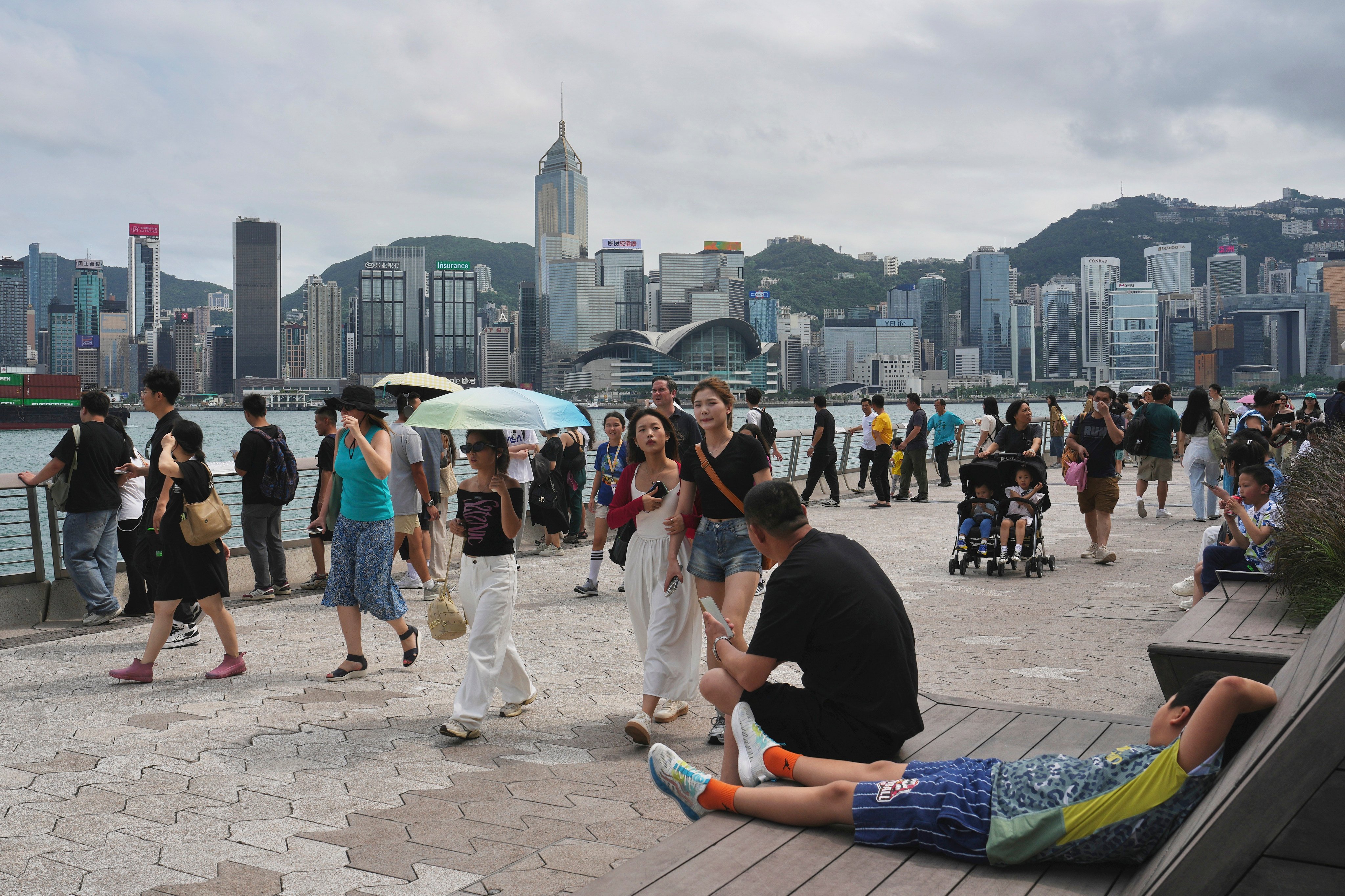 Tourists take in the sights along the Tsim Sha Tsui Promenade. Photo: Elson Li