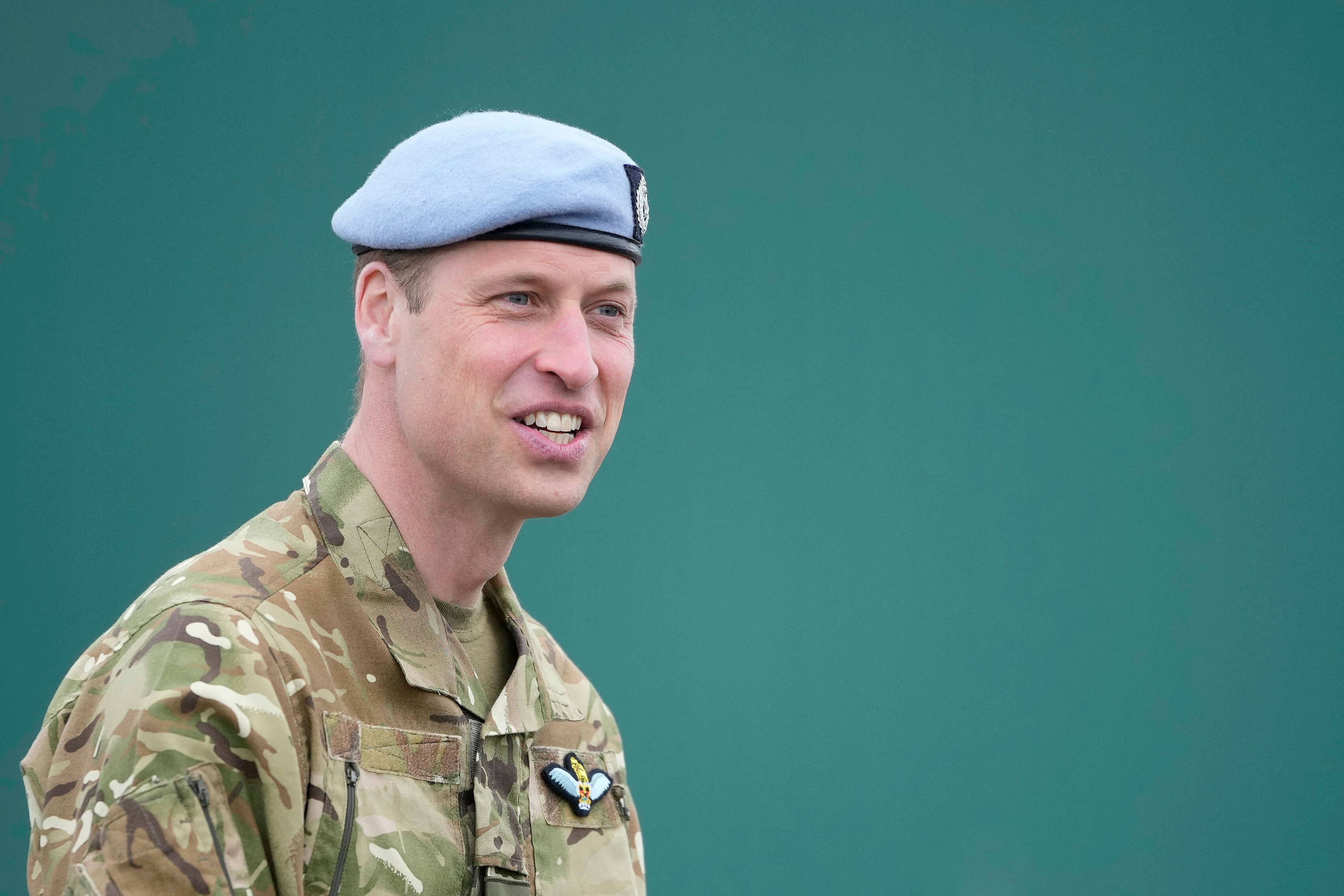 Britain’s Prince William, Prince of Wales speaks to service personal at the Army Aviation Centre in Middle Wallop, England on Monday. Photo: Pool/AFP