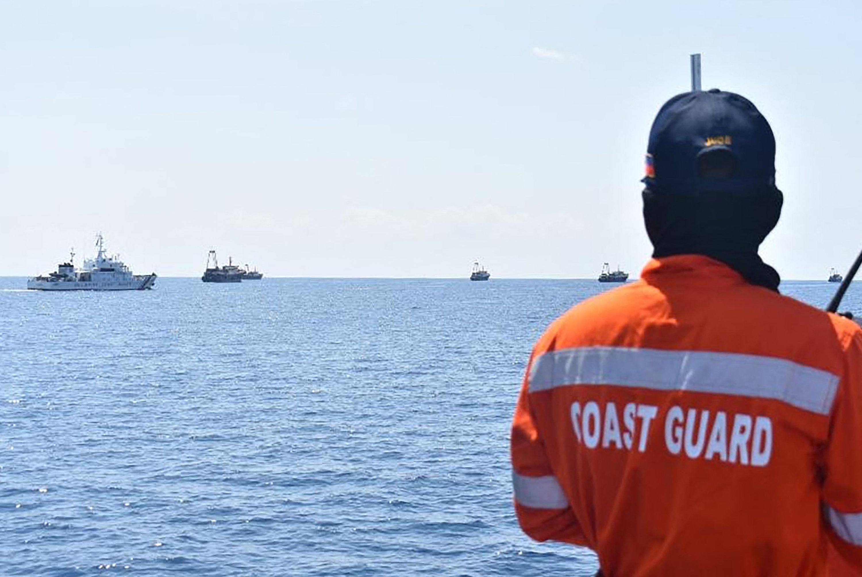 Philippine coastguard personnel aboard their ship BRP Cabra monitoring Chinese vessels at Sabina Shoal, a South China Sea outcrop. Photo: AFP 