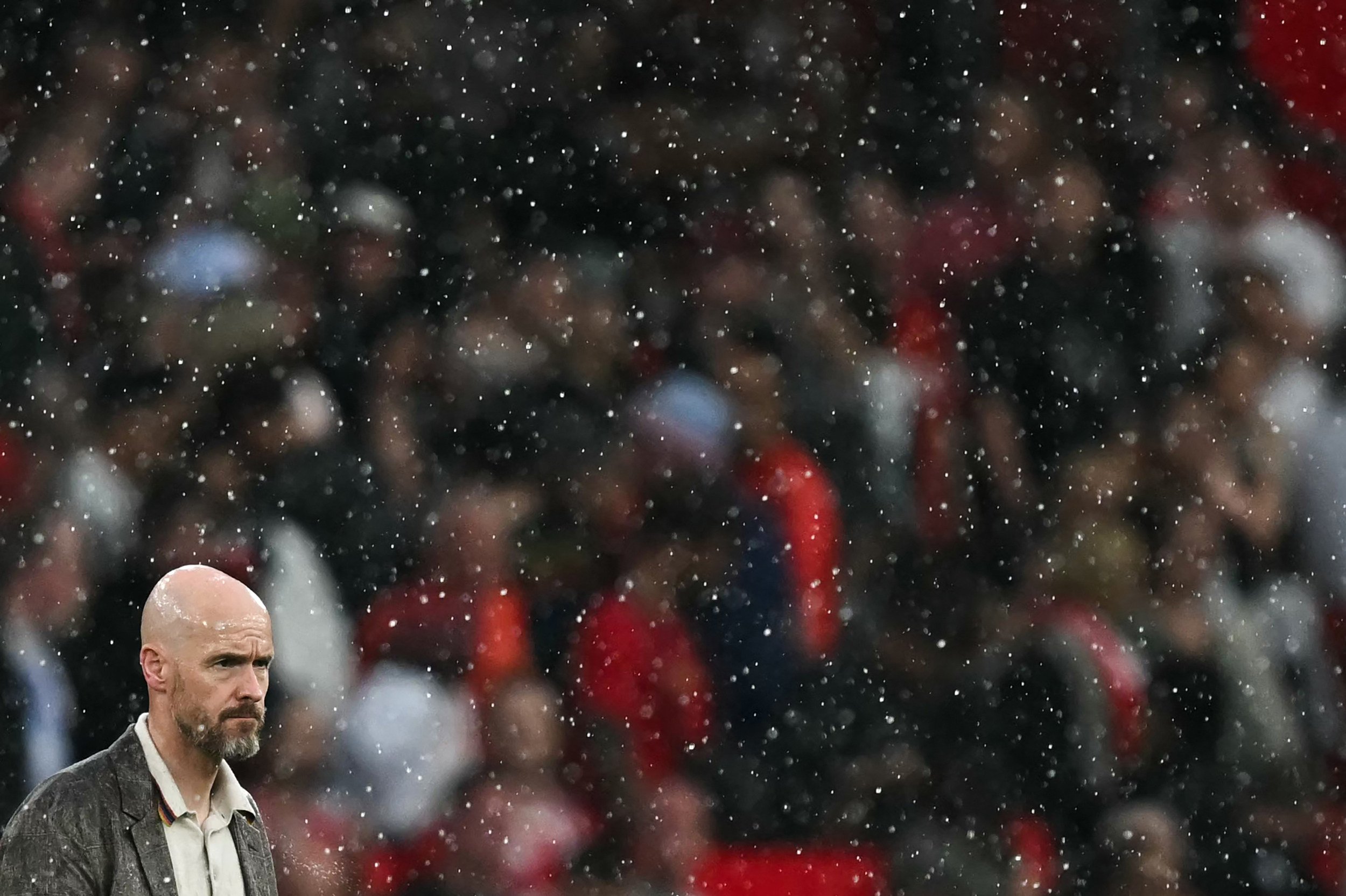 Manchester United manager Erik ten Hag watches on in the heavy rain as his team lose 1-0 at home to Arsenal. Photo: AFP