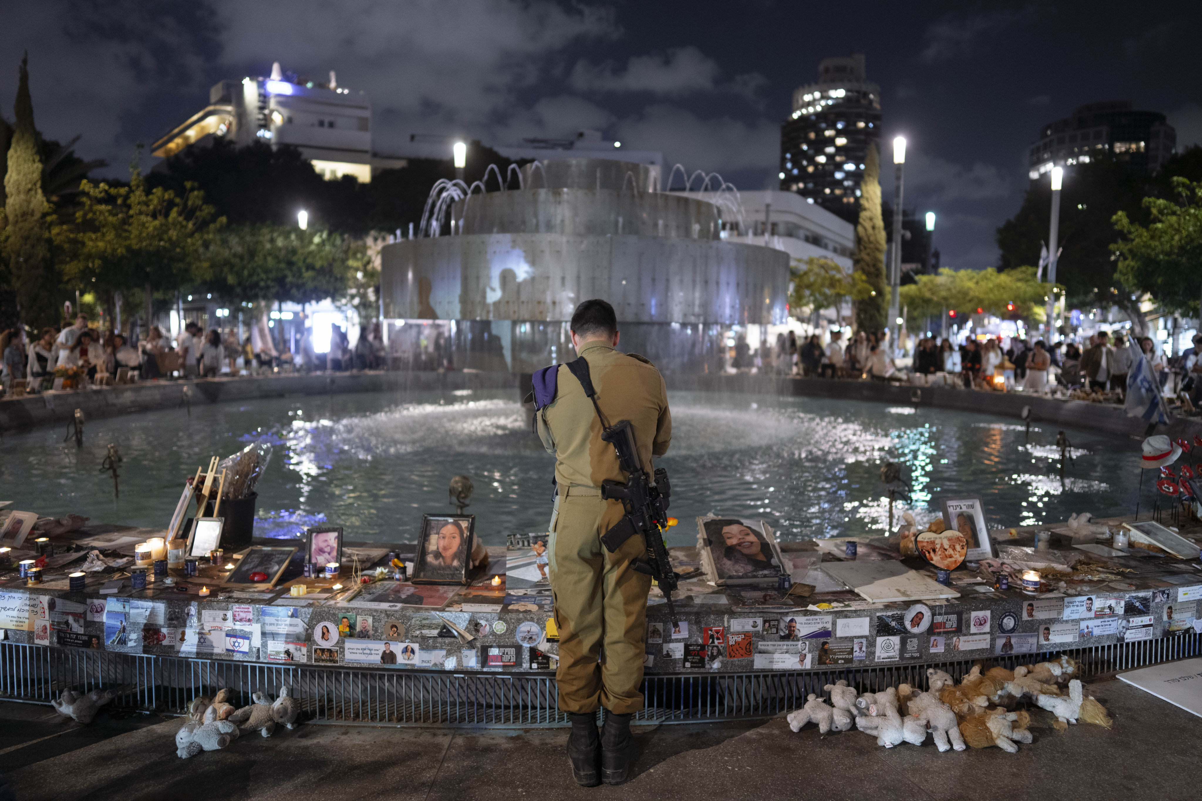 An Israeli soldier in Tel Aviv pays respect at a memorial for victims of the bloody October 7 attack. Photo: AP