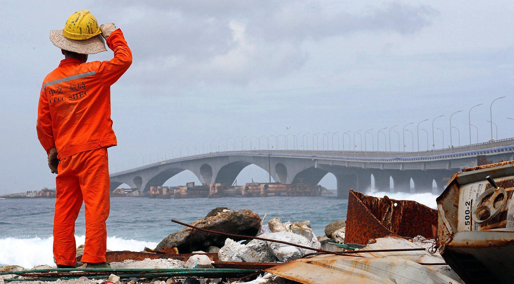 A construction worker looks on as the China-funded Sinamale bridge is seen in Male, Maldives. Photo: Reuters
