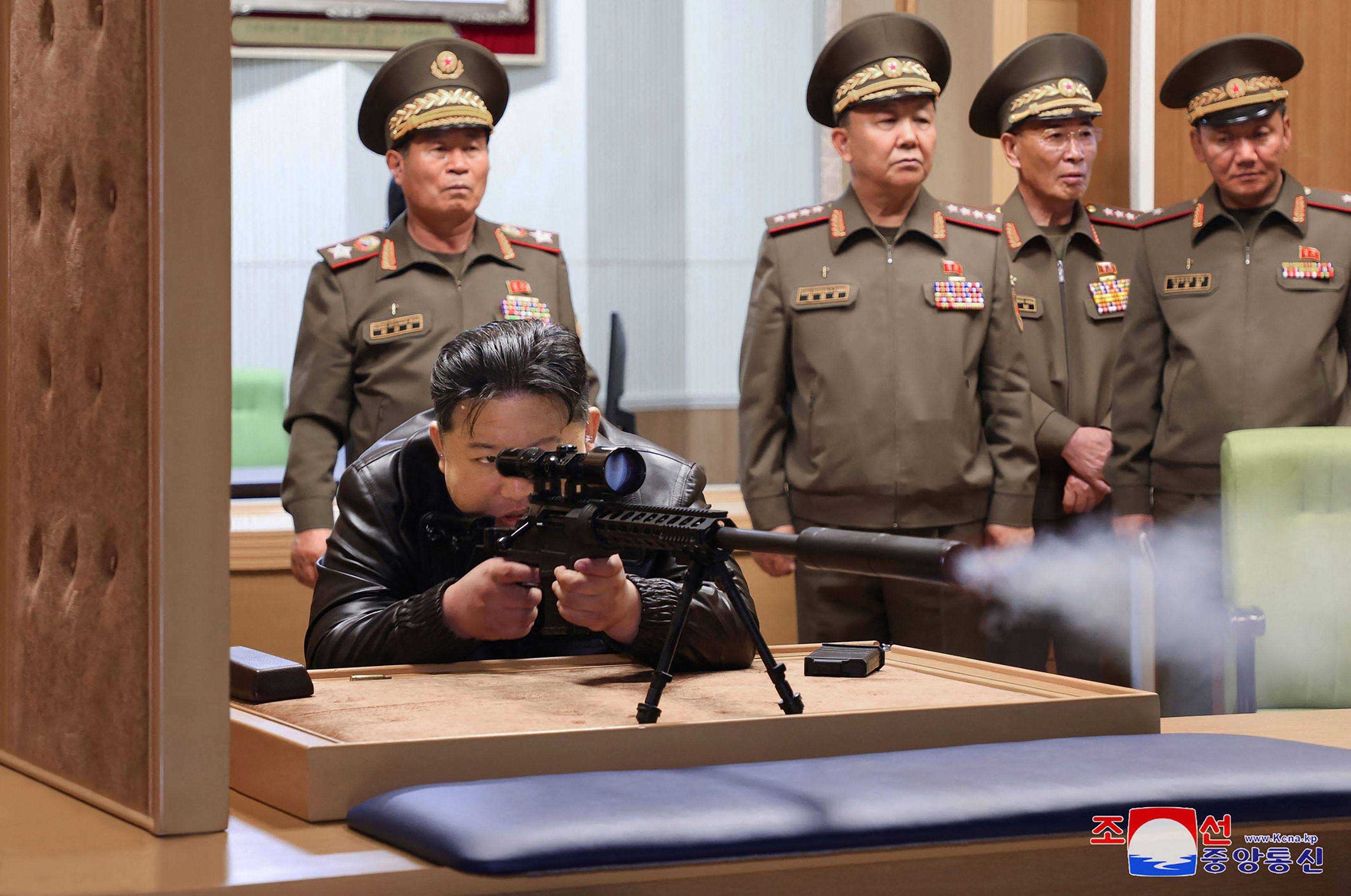 North Korean leader Kim Jong-un tests a sniper rifle during a visit to an arms manufacturer at an undisclosed location over the weekend. Photo: KCNA via KNS / AFP
