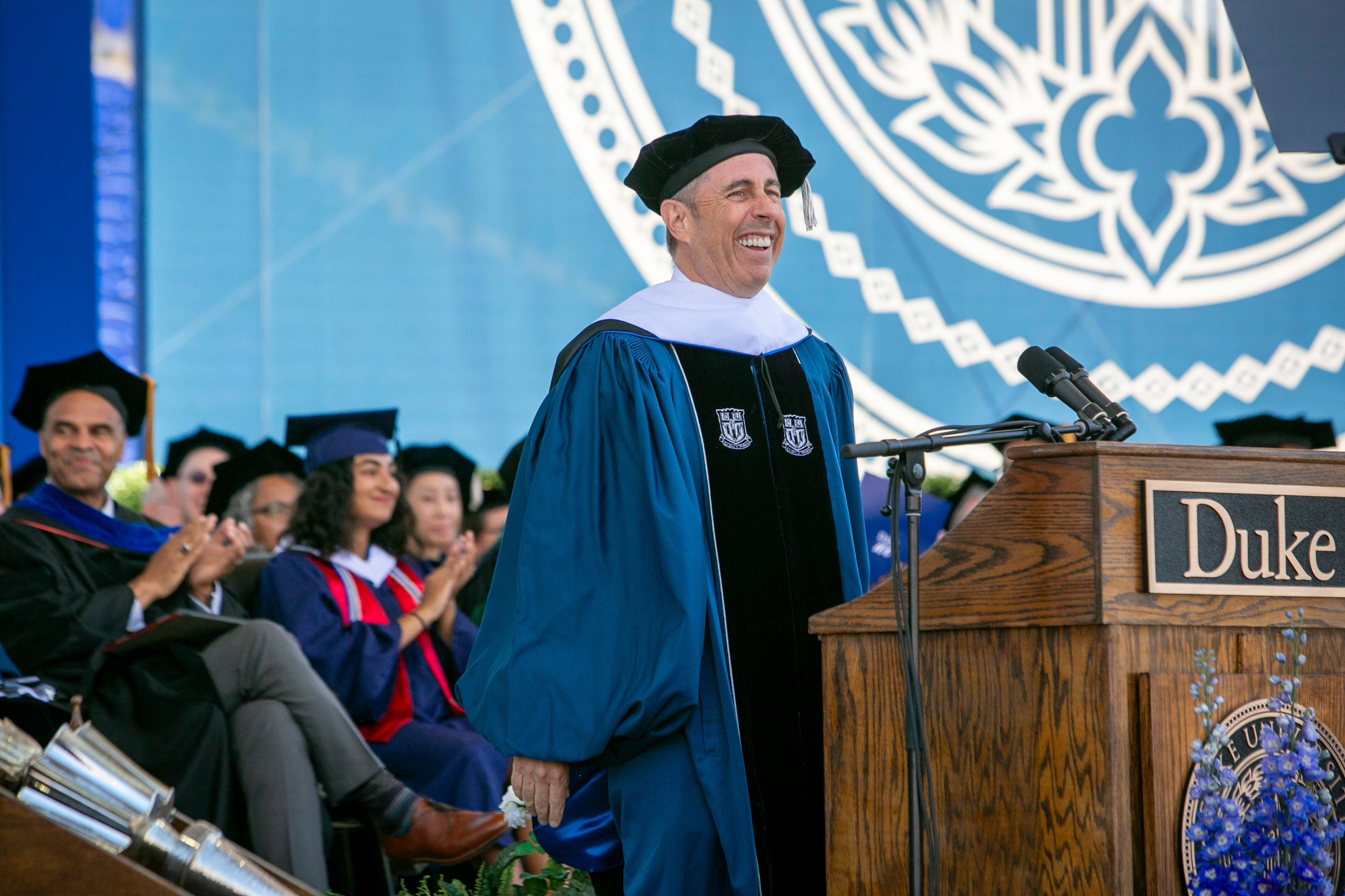 Jerry Seinfeld laughs on stage during the  graduation ceremony. Photo: Duke University via AP