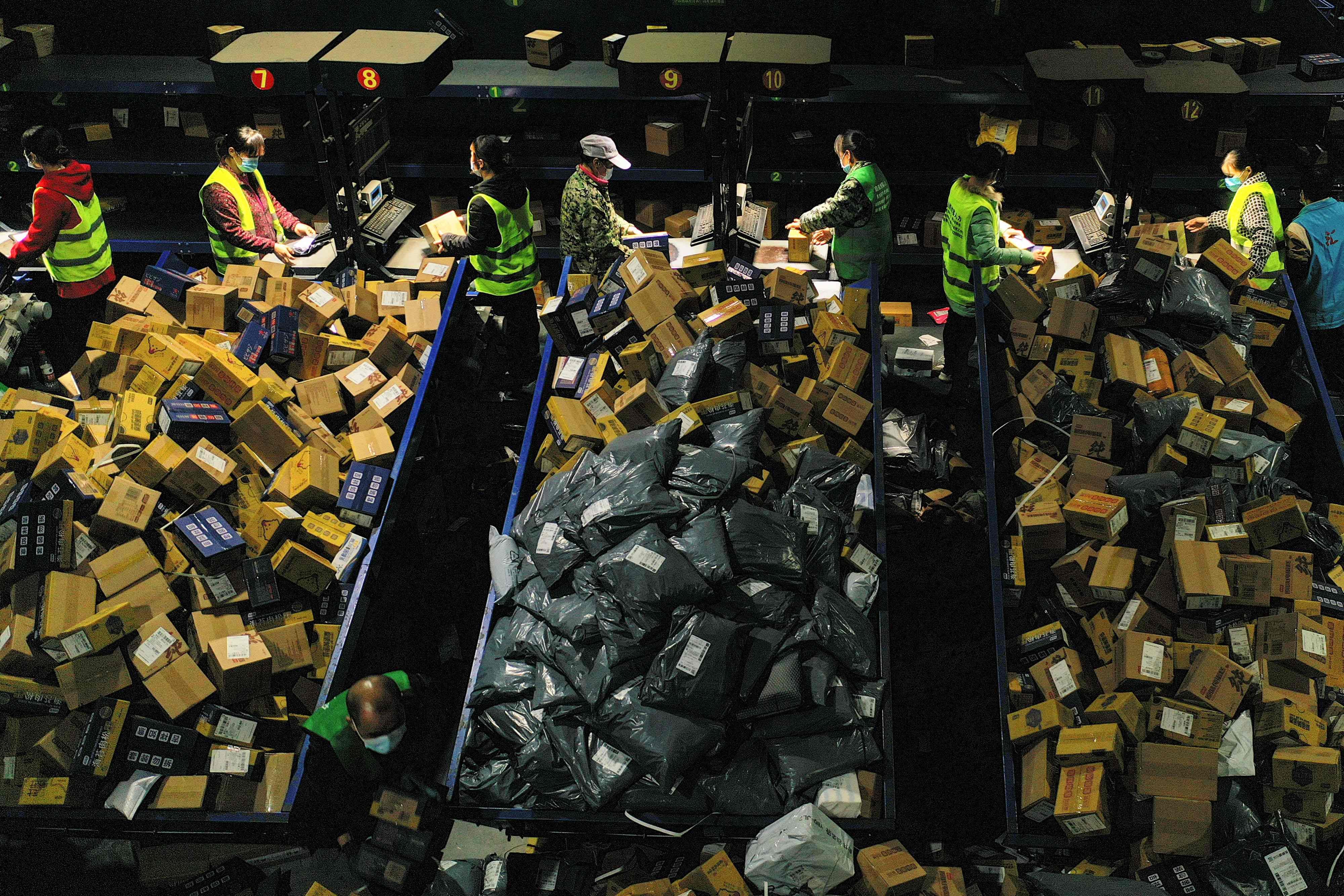 Workers sort packages at a logistics company in the China’s Hunan province on November 12, 2021, a day after the annual Singles’ Day online shopping gala. Photo: AFP