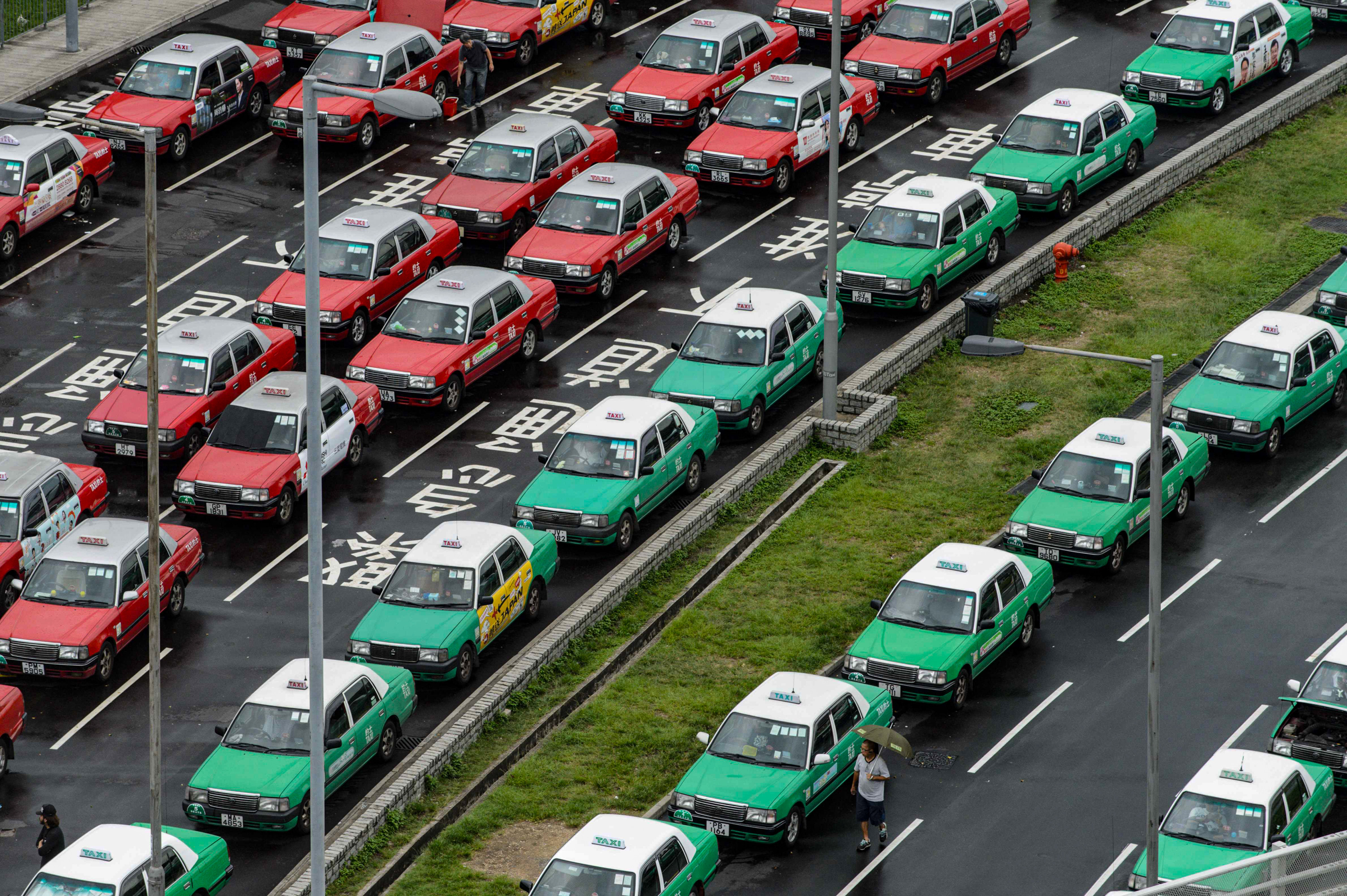 Red and green taxis line up in ranks. Photo: AFP