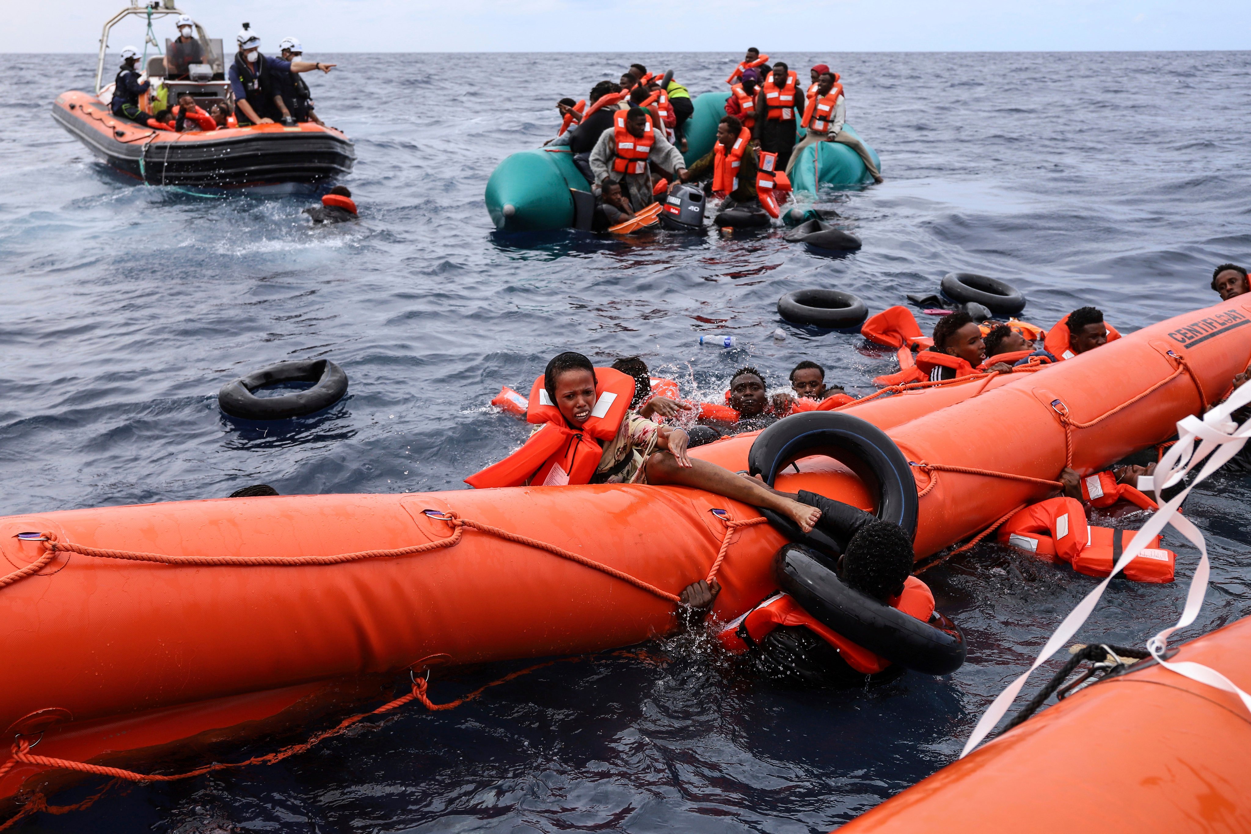Migrants aboard a rubber boat end up in the water, while others cling on to a centifloat before being rescued near Libya. EU nations passed sweeping new reforms to the bloc’s failed asylum system. Photo: AP/File