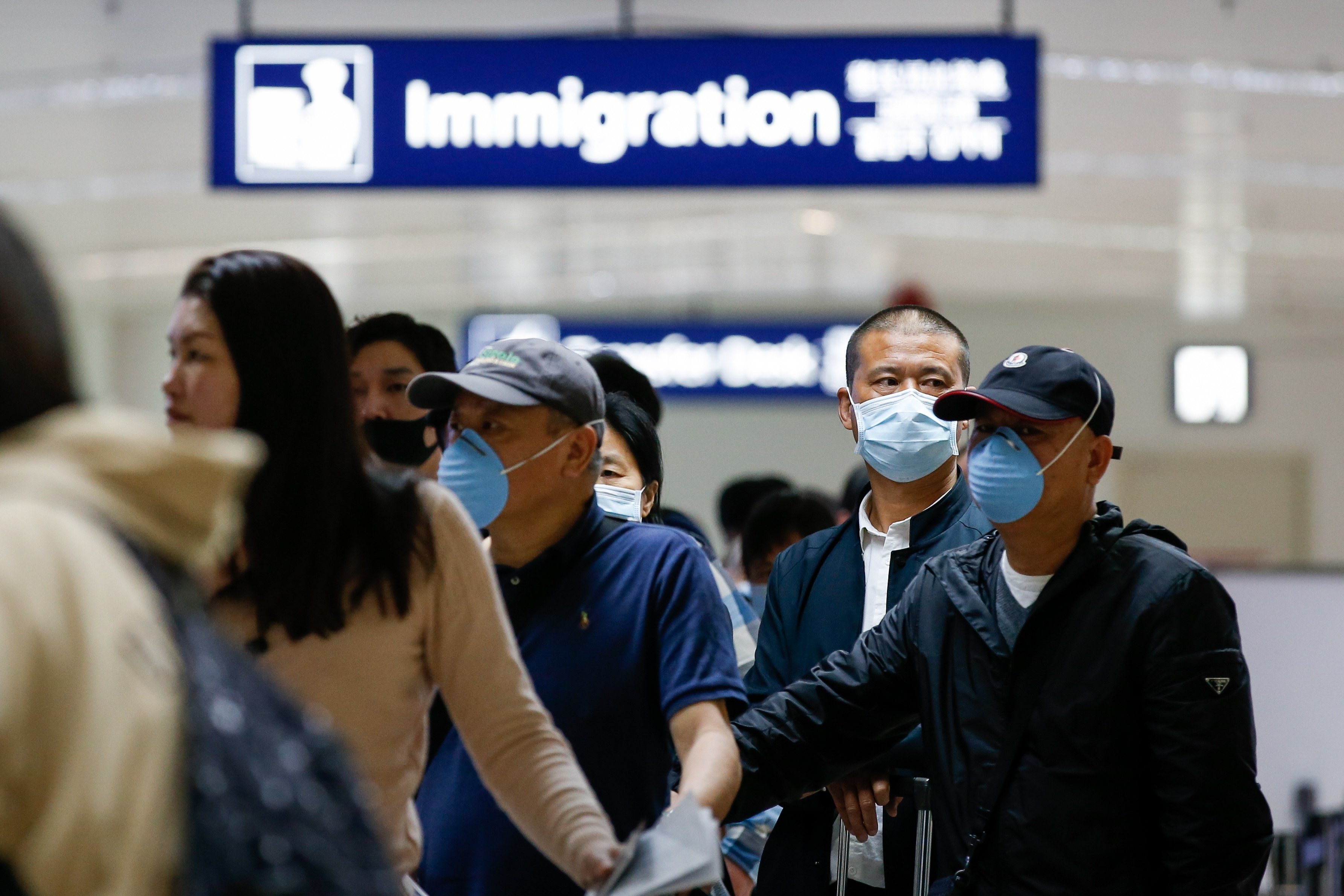 Passengers who arrived from Guangzhou, China line up for immigration at the Ninoy Aquino International Airport in Manila. Photo: EPA-EFE