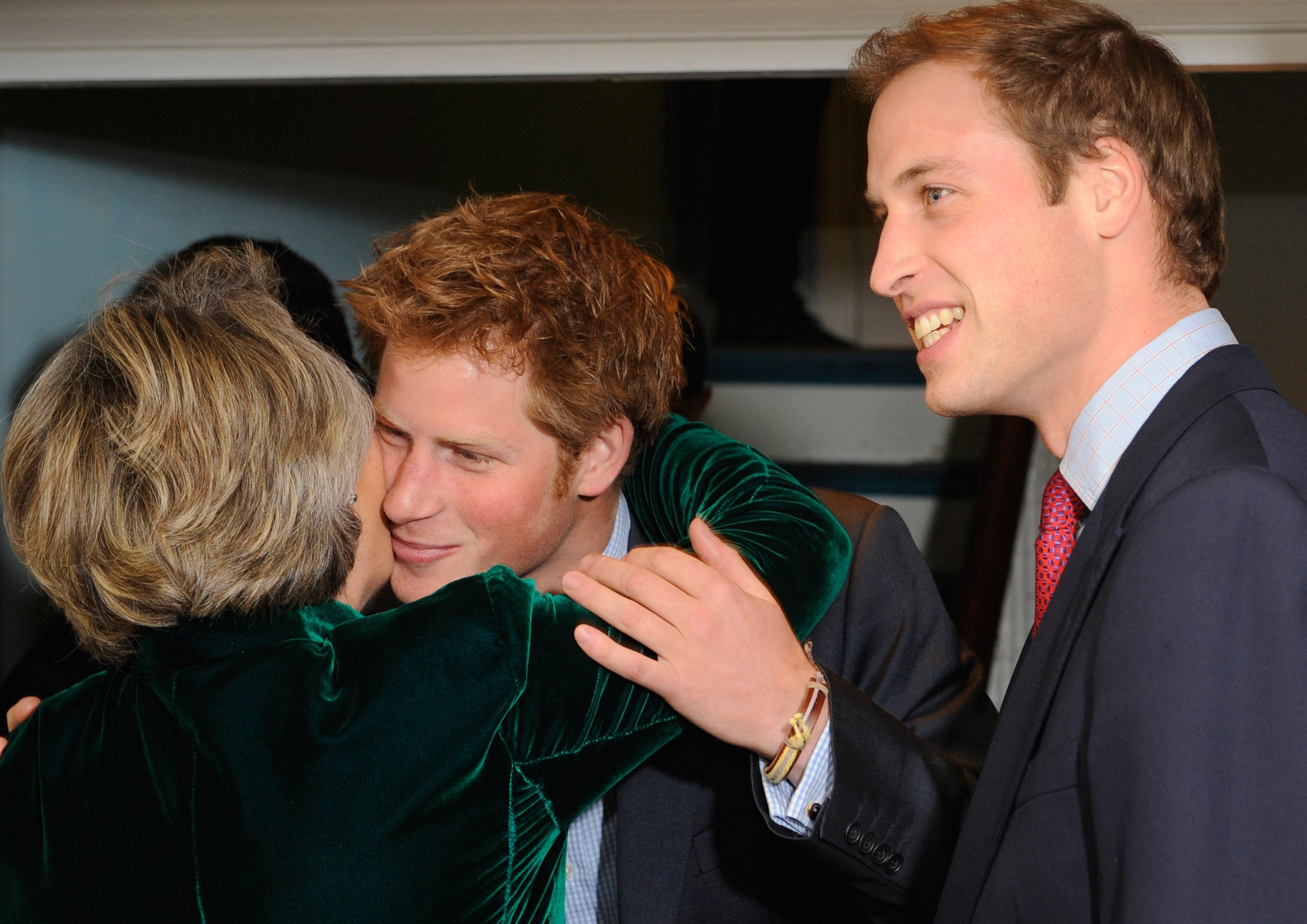 Prince Harry embracing Claire van Straubenzee as his brother Prince William looks on at the formal launch of the Henry Van Straubenzee Memorial Fund in 2009. Photo: WPA/Getty Images