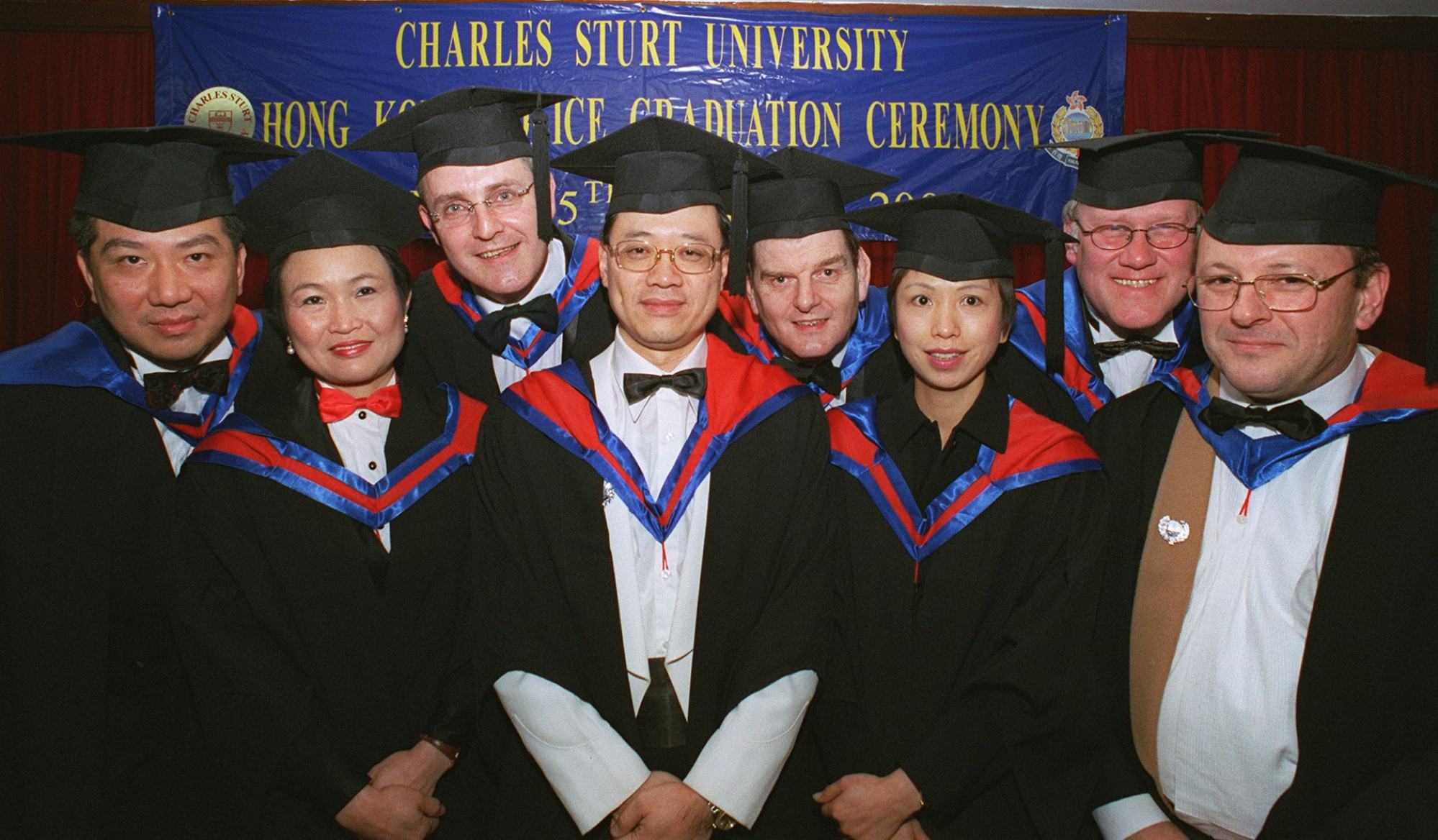 Bill Yuen (left) and John Lee (centre) attend a graduation ceremony in 2002 after completing a self-learning course by Charles Sturt University. Photo: Steve Cray