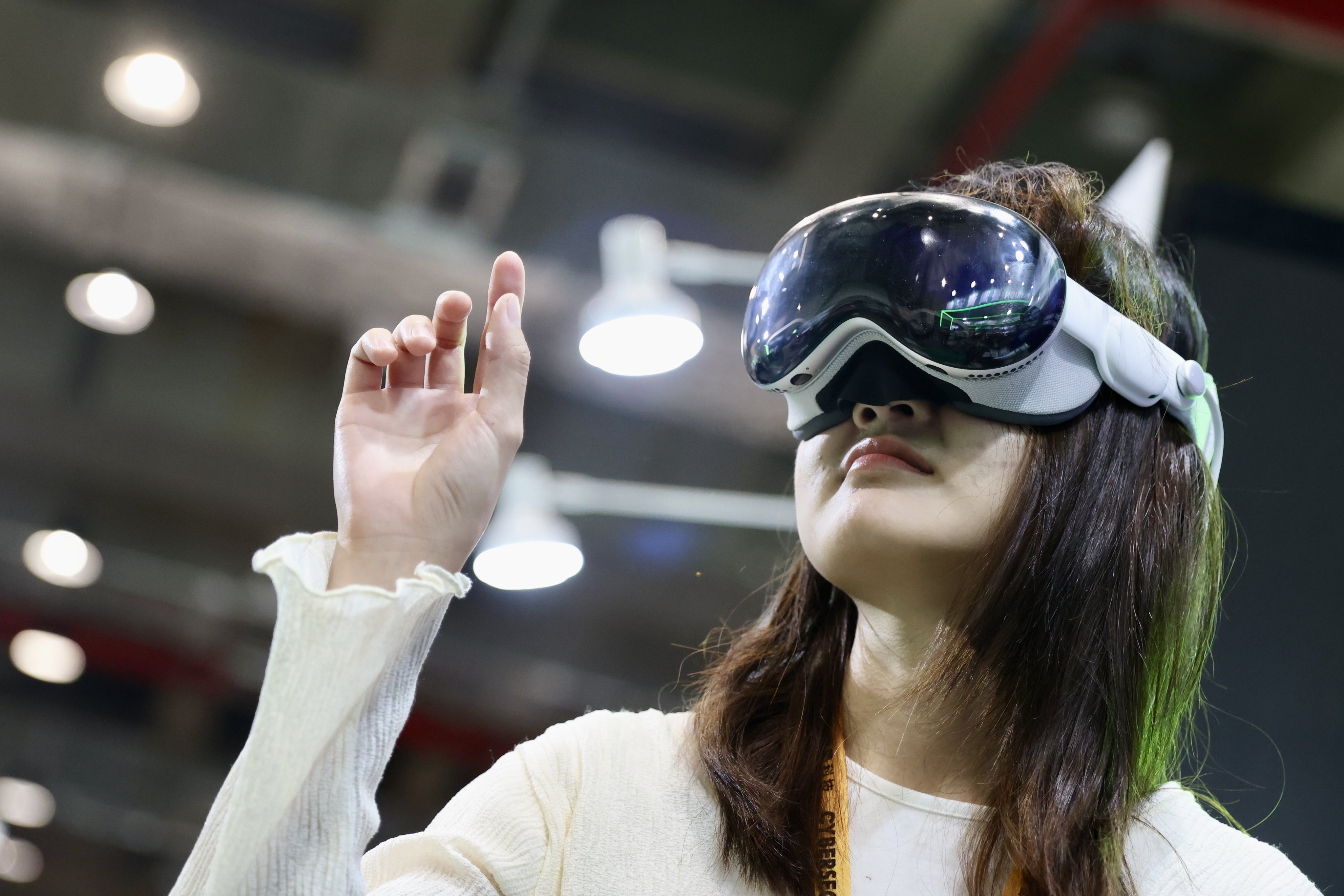An attendee tries on Apple’s Vision Pro mixed-reality headset at Tuesday’s opening of the CYBERSEC 2024 expo in Taipei. The 10th edition of the cybersecurity event concludes on May 16. Photo: EPA-EFE