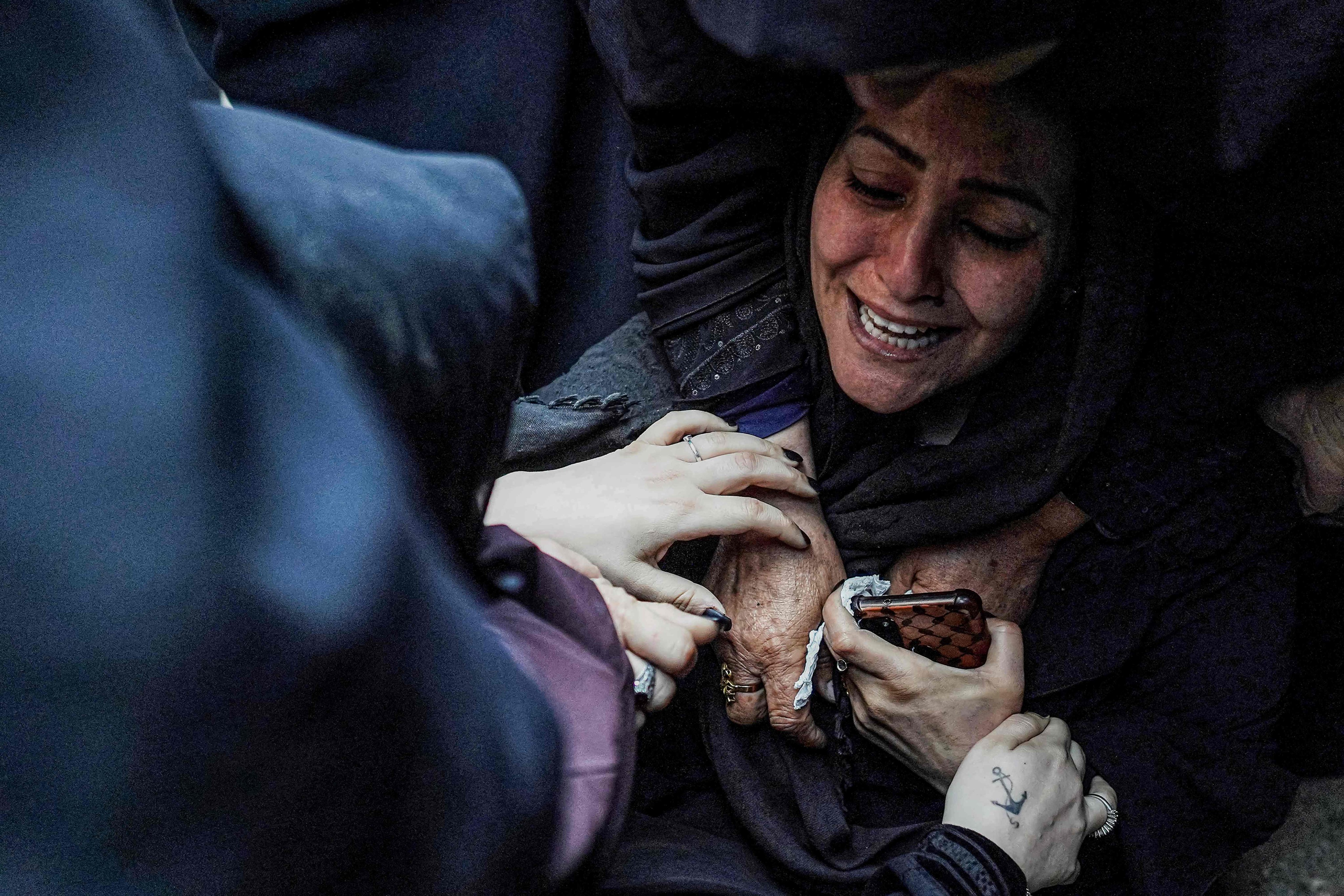 A mother is comforted by other women as she mourns the death of her child in an Israeli bombardment in Nuseirat in the central Gaza Strip. Photo: AFP