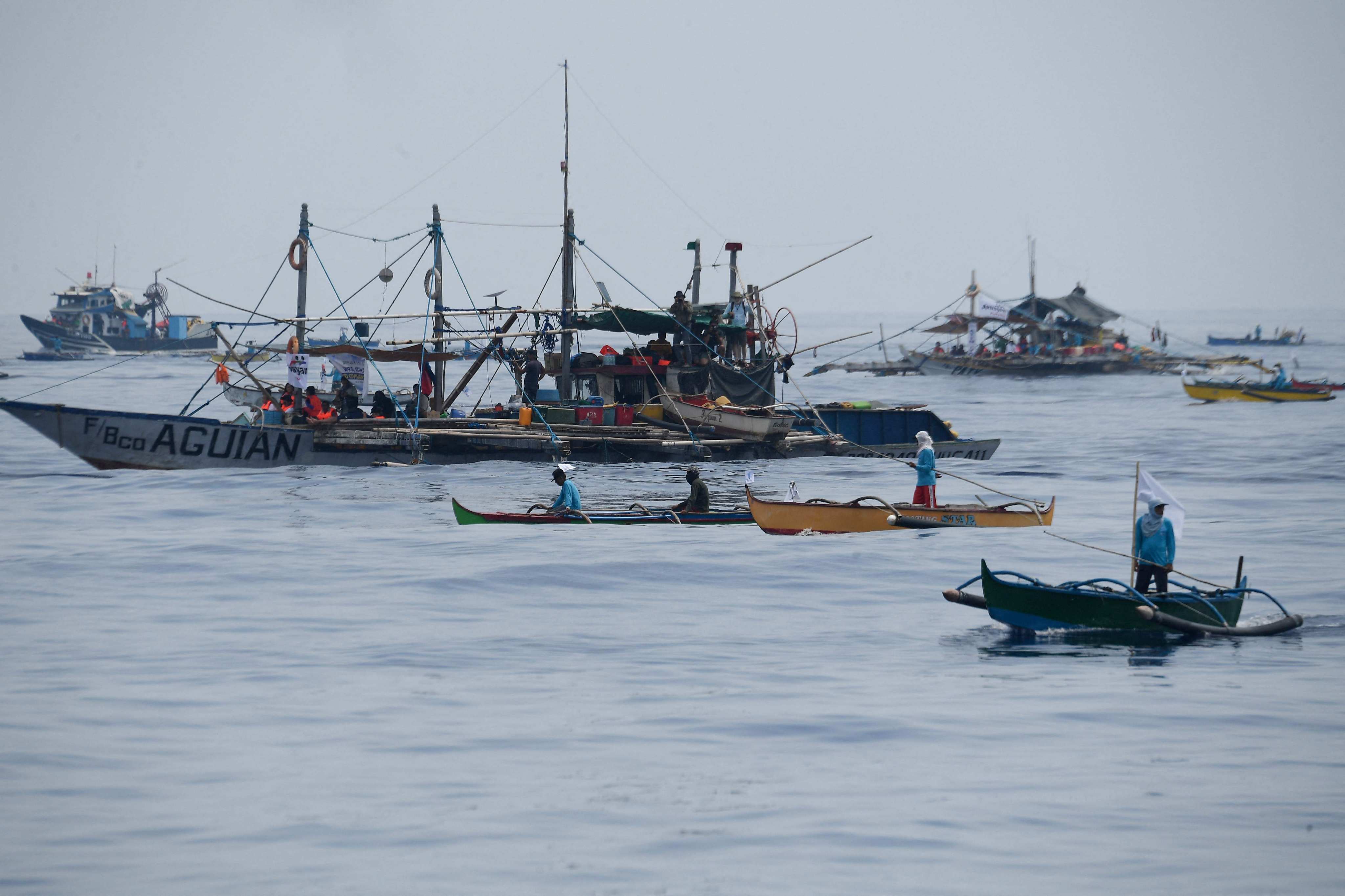 Philippine fishermen along with volunteers from a civilian-led mission Atin Ito Coalition arrive at a meeting point in the South China Sea on Wednesday. Photo: AFP