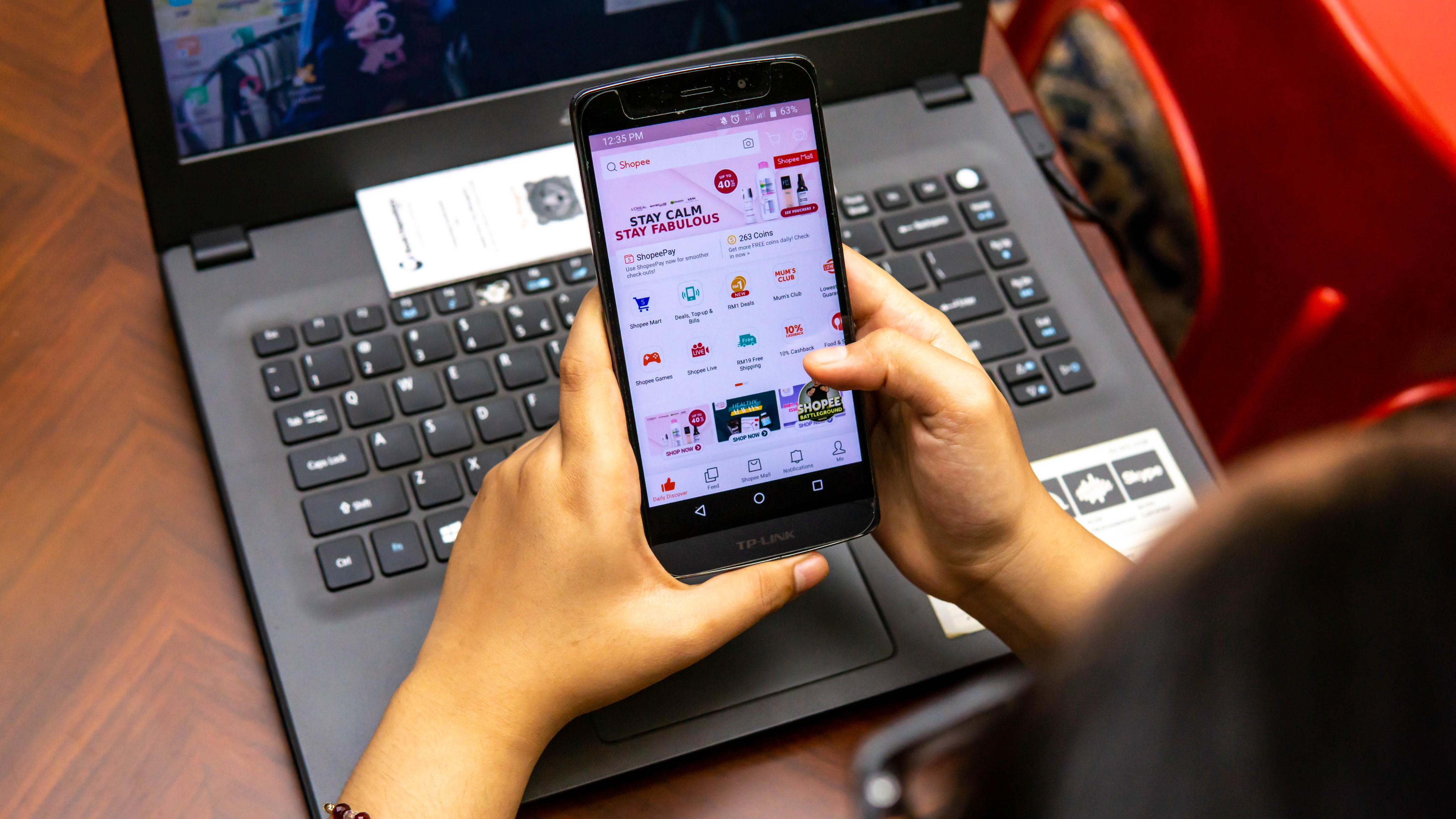 A girl in Malaysia using a smartphone to search and buy things online. Photo: Shutterstock