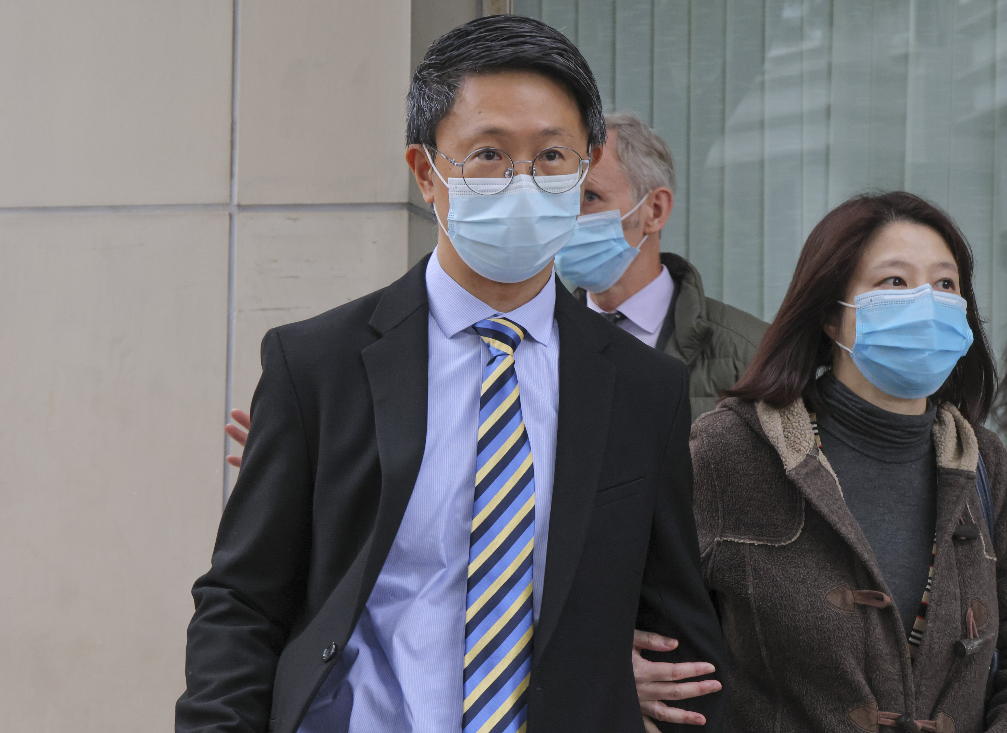 Lam Chi-kwan (middle), a doctor at United Christian Hospital, leaves the Eastern court in Sai Wan Ho in January 2023. He and fellow doctor Chan Siu-kim, had been charged with manslaughter over the death of Tang Kwai-sze, in 2017. Photo: Jelly Tse