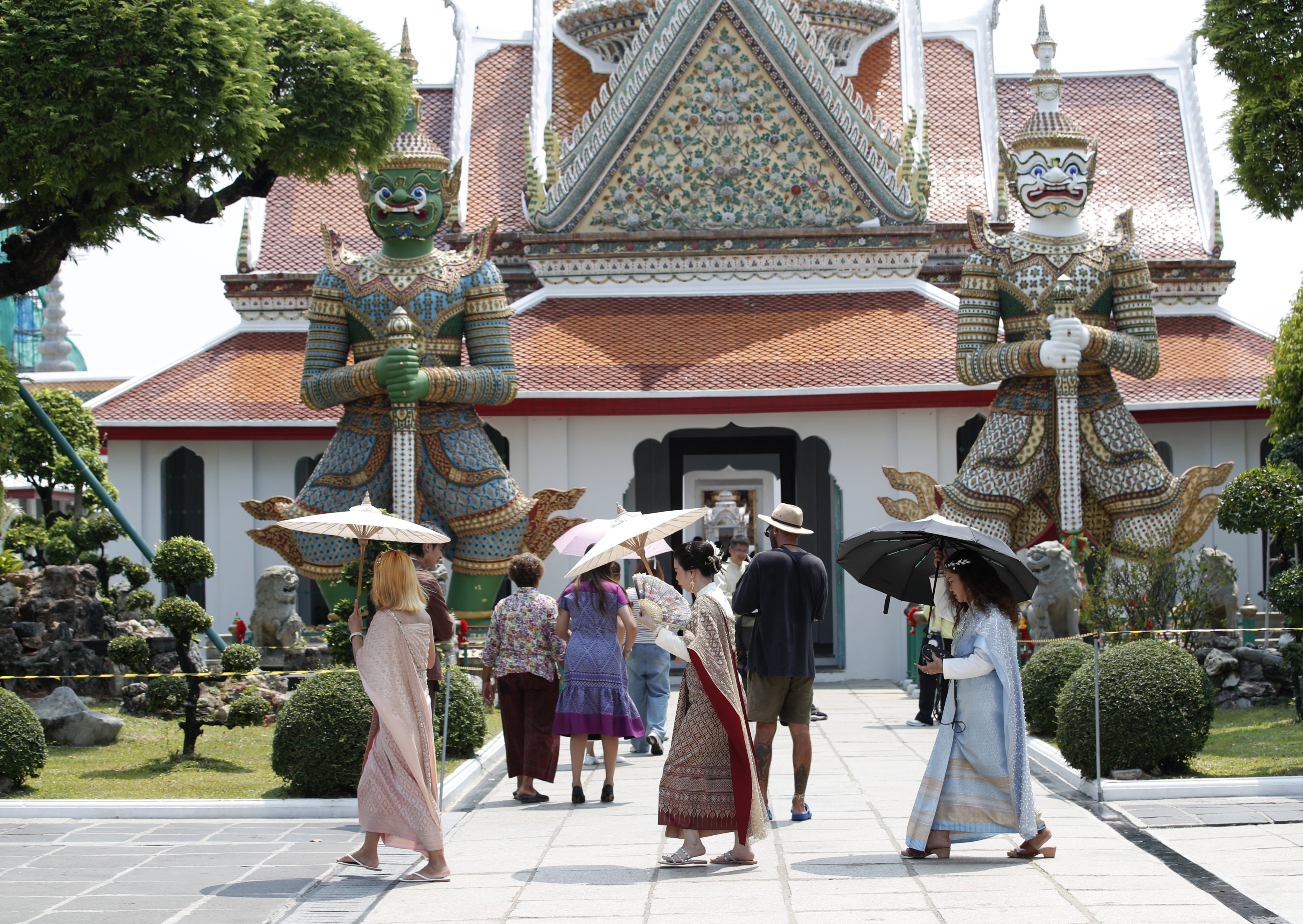 Tourists at Bangkok’s Temple of Dawn. Projections consistently show that low-lying Bangkok risks being inundated by the ocean before the end of the century. Photo: EPA-EFE