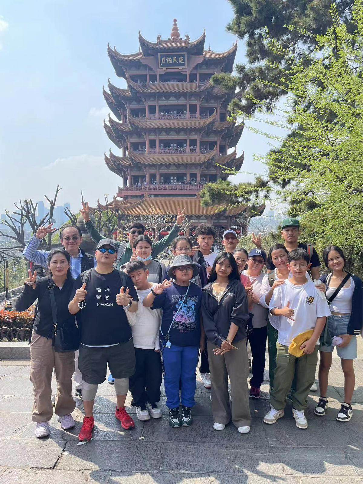 Integrated Brilliant Education Limited students and their family members stand in front of Wuhan’s Yellow Crane Tower. Photo: Handout