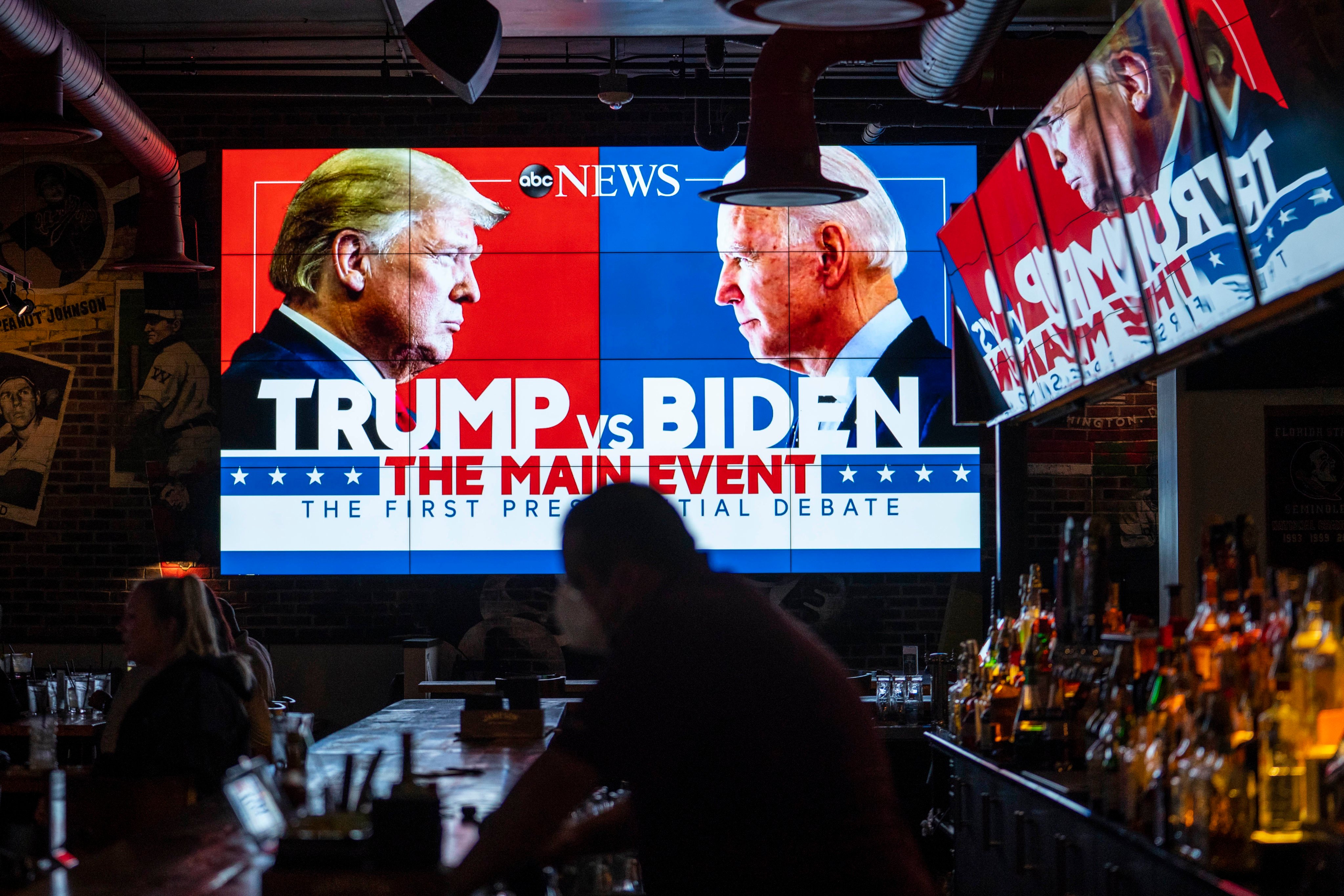 Television screens airing a presidential debate Donald Trump and Joe Biden. Photo: Getty Images