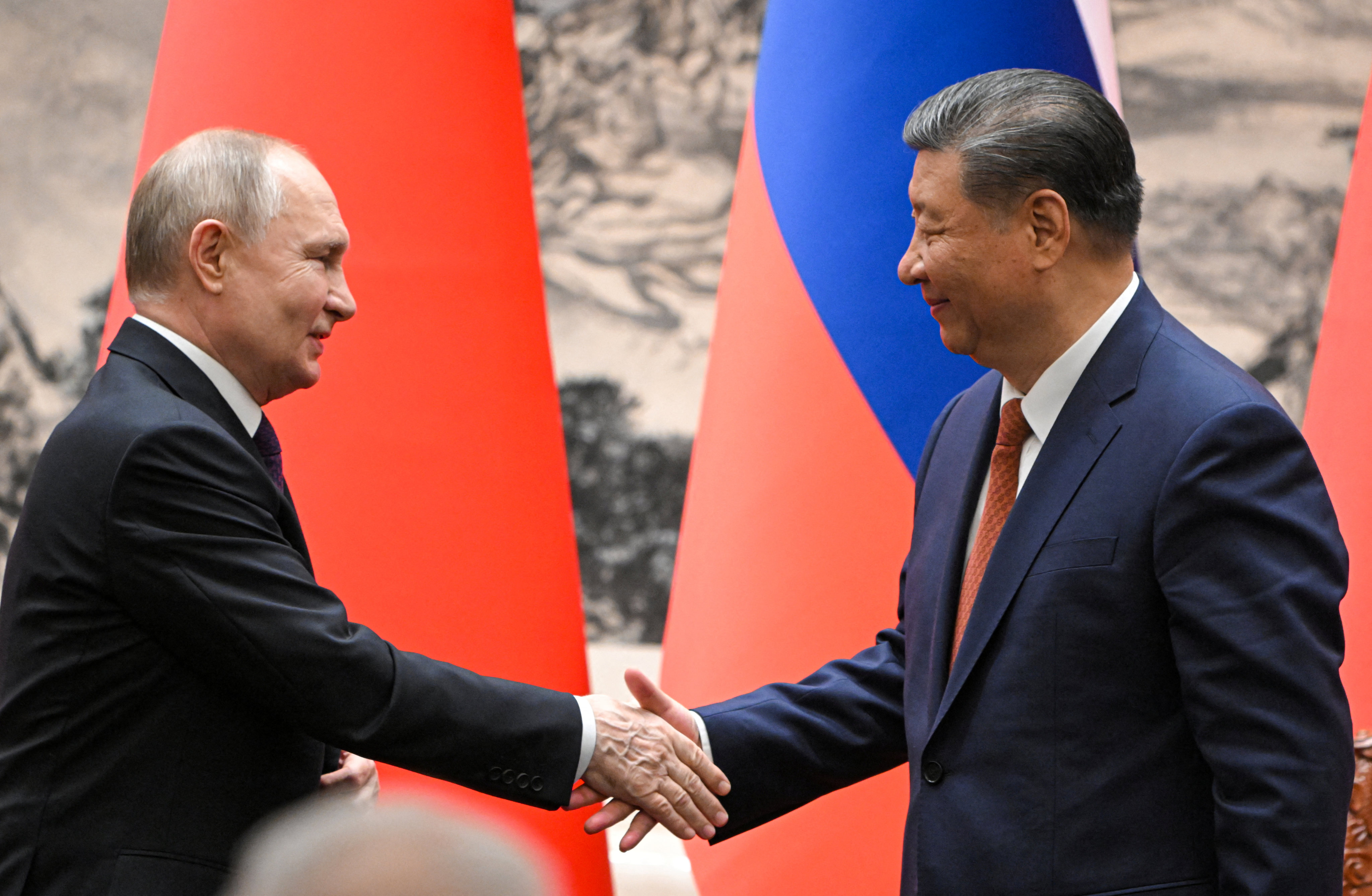 Russian President Vladimir Putin shakes hands with Chinese President Xi Jinping during a meeting in Beijing on Thursday. Photo: Reuters