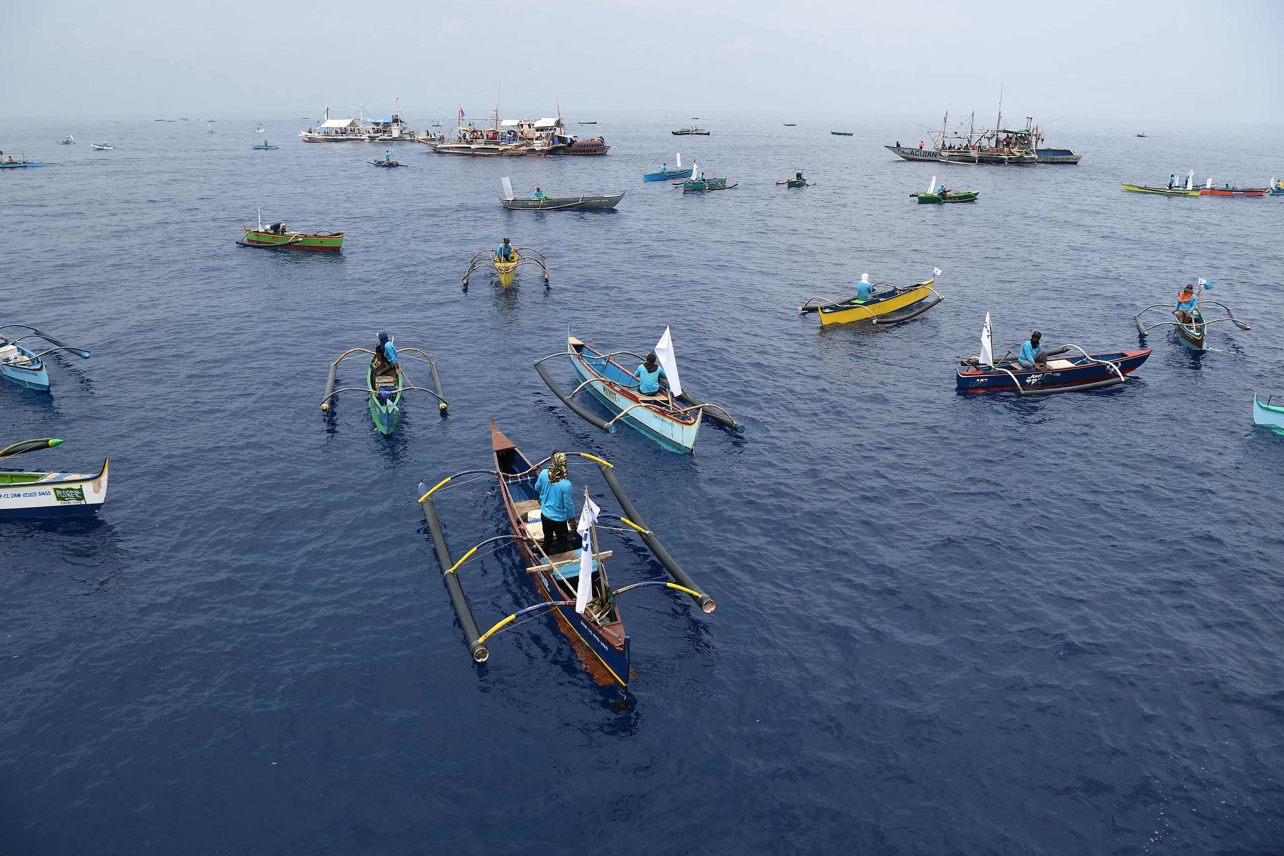Philippine fishermen and volunteers from a civilian group arrive at a meeting point in the South China Sea on May 15. Photo: AFP
